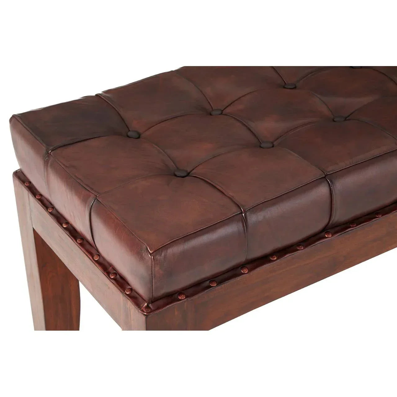 Brown leather bench with button tufted seat and wooden legs, close-up view