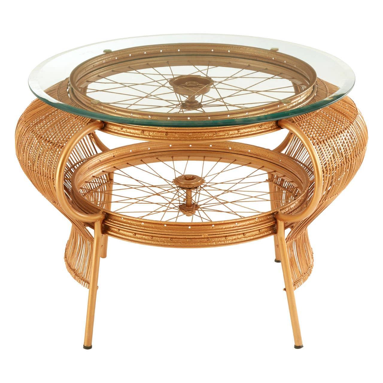 Round glass coffee table with gold metal bicycle wheel frame and woven rattan detailing