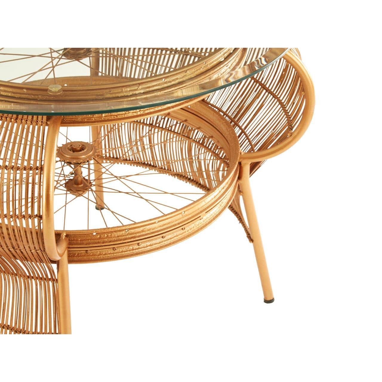 Round rattan coffee table with glass top and gold woven frame detail