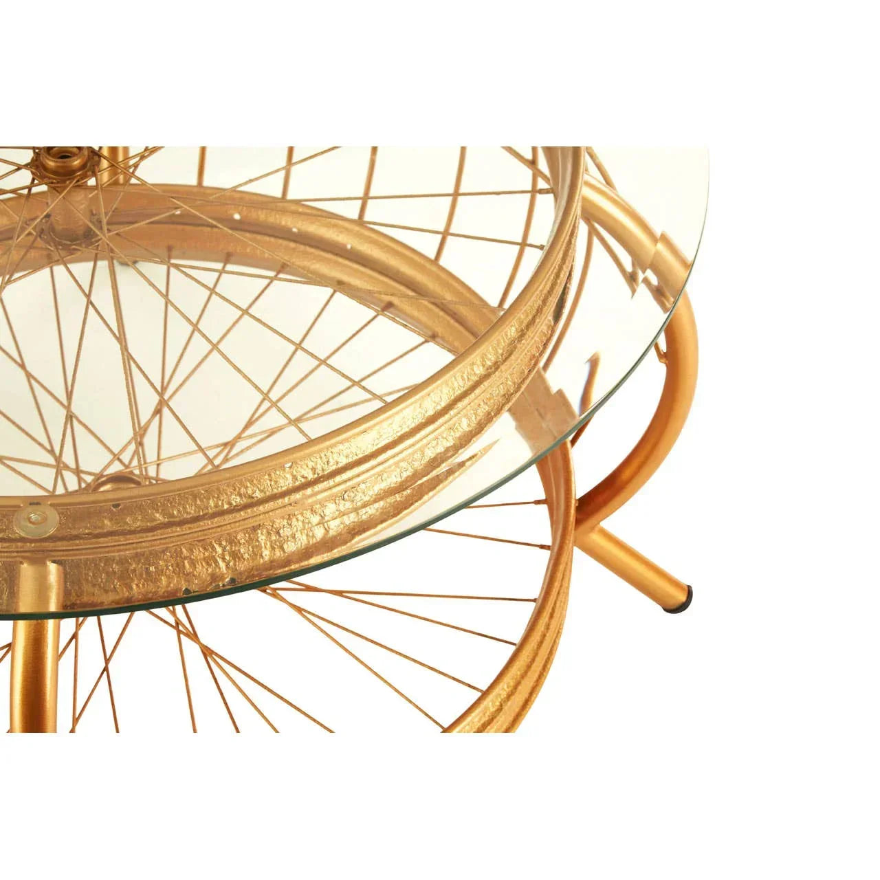 Round glass coffee table with gold metal bicycle wheel base, close-up angle