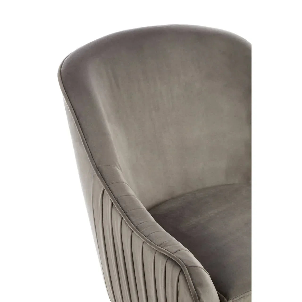 Grey velvet armchair with curved backrest and pleated side detail, close-up angle