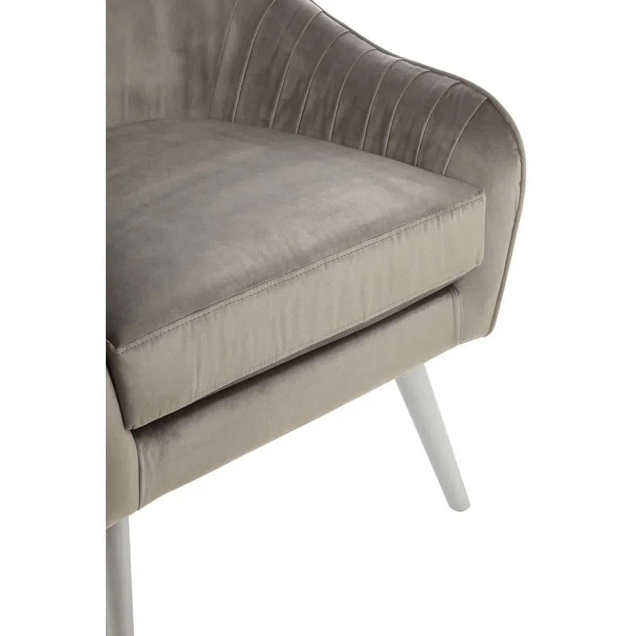 Close view of grey velvet armchair cushion and angled wooden legs