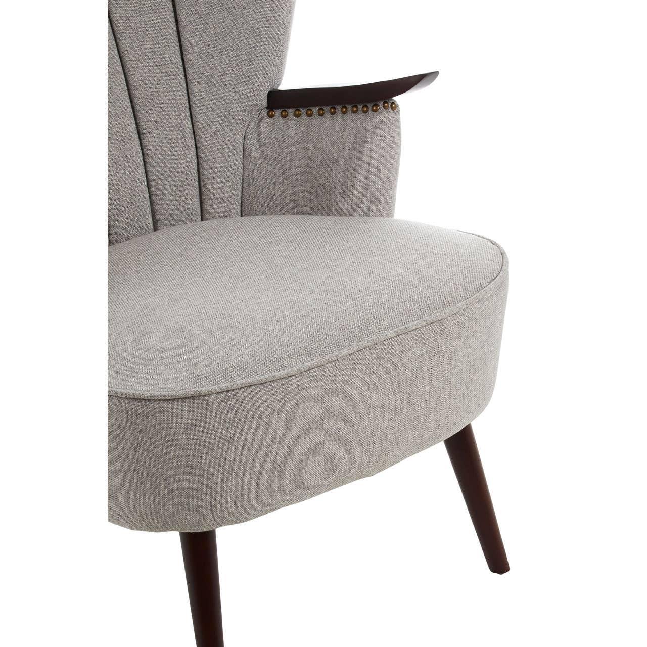Light grey fabric accent chair with studded armrest and dark wooden legs
