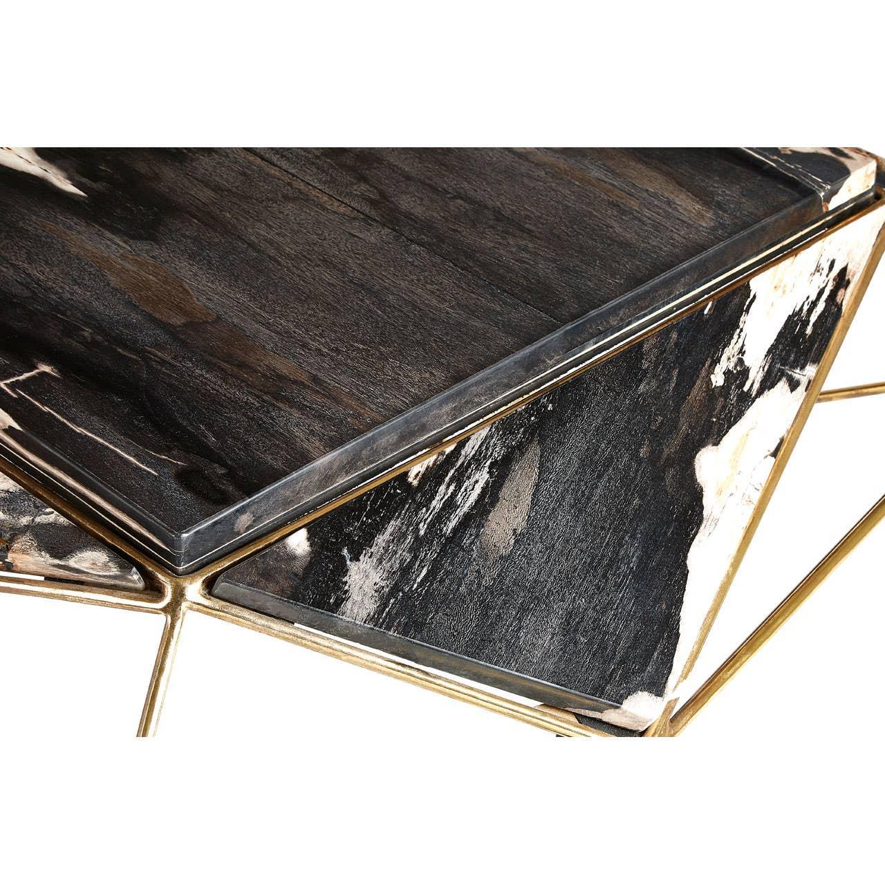 Modern coffee table with black and white wood panels and gold metal geometric frame