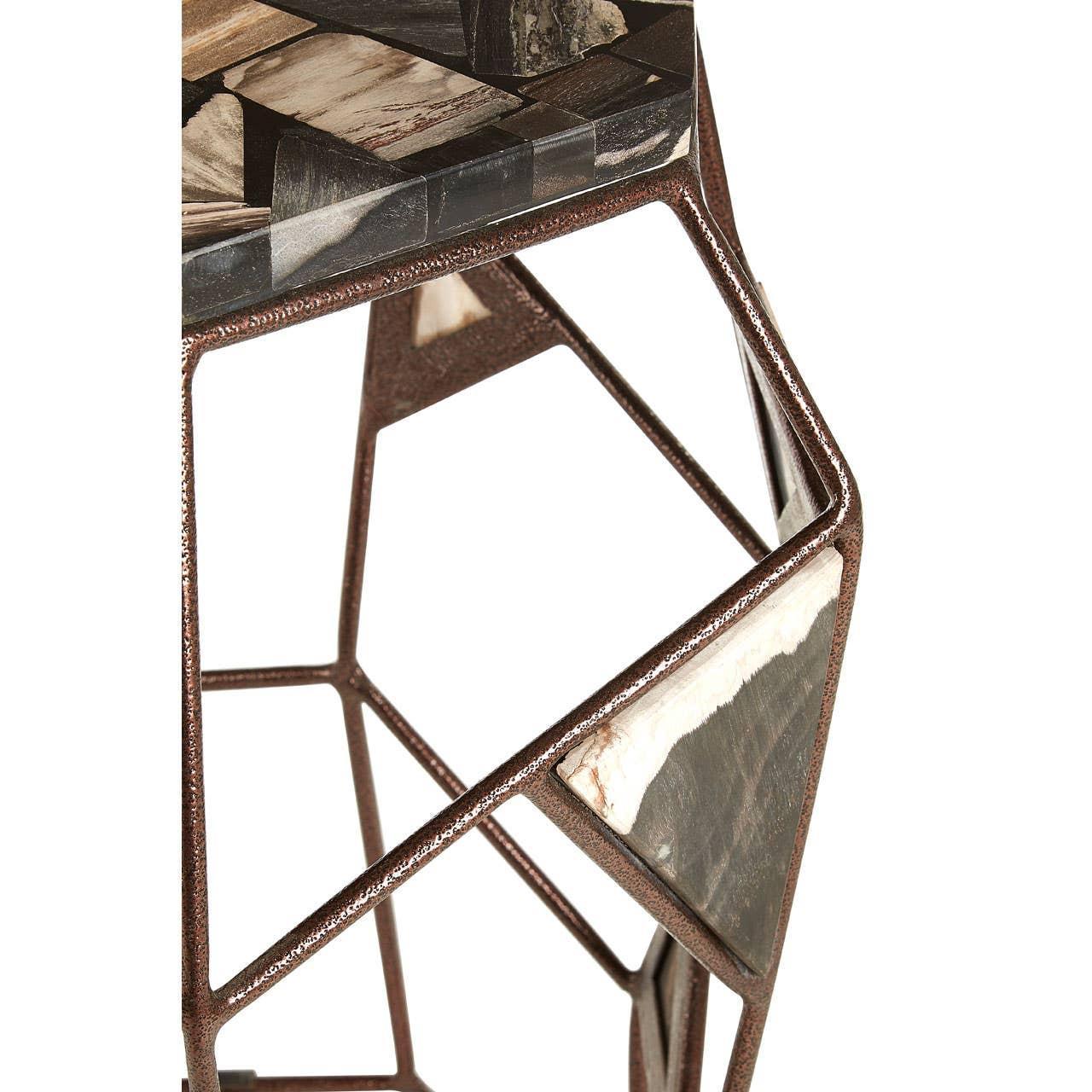 Geometric metal side table with mosaic stone inlay and brown bronze frame, close-up view