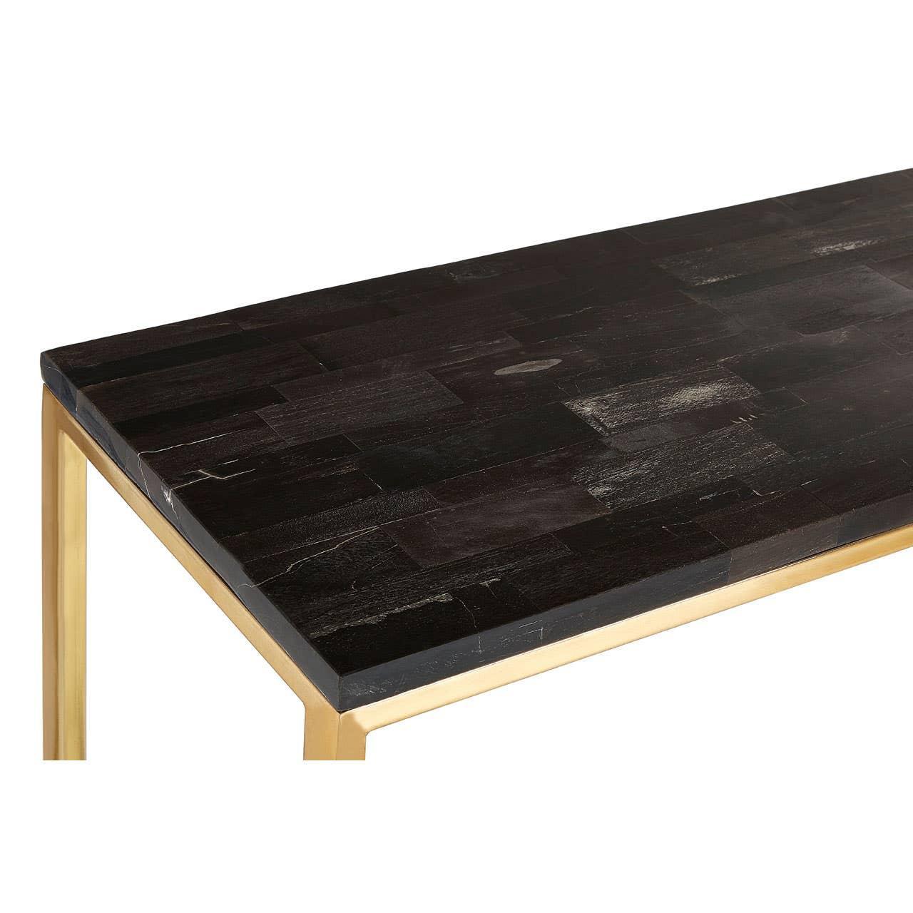 Rectangular black wood dining table with gold metal legs, corner angle view