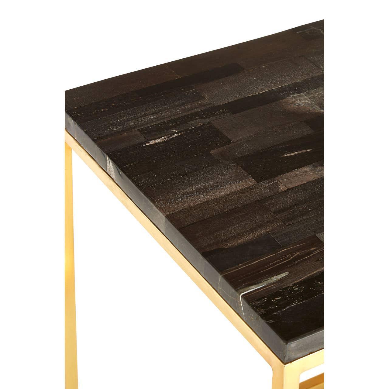 Dark wood dining table top with gold metal frame, angled close-up view