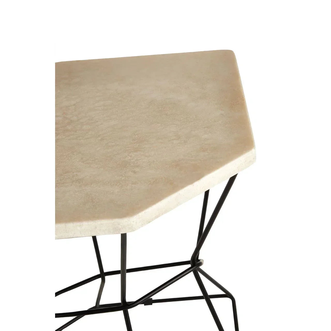 Beige stone side table top with black geometric metal legs, close-up view