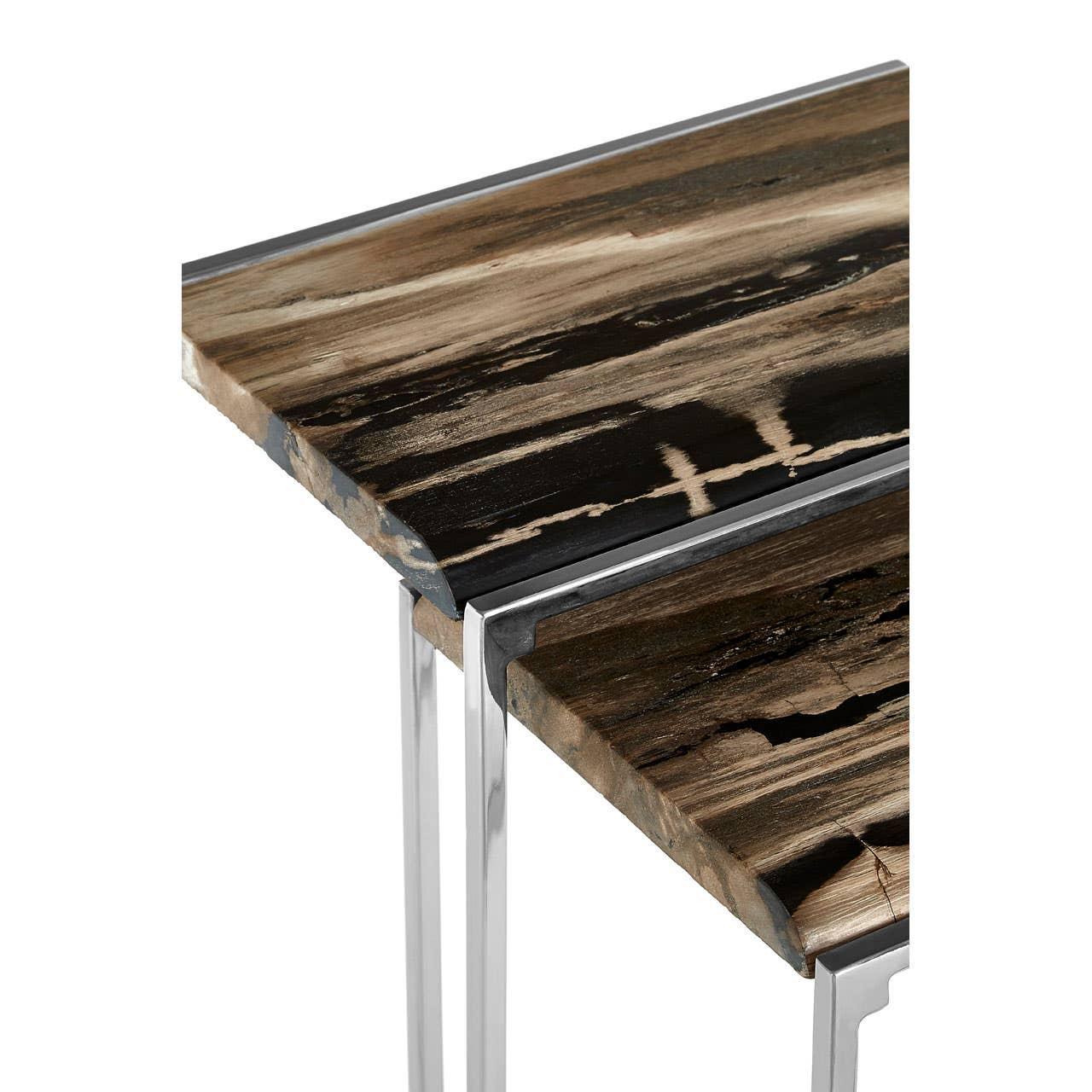 Nesting tables with polished metal legs and dark woodgrain tops in close-up view