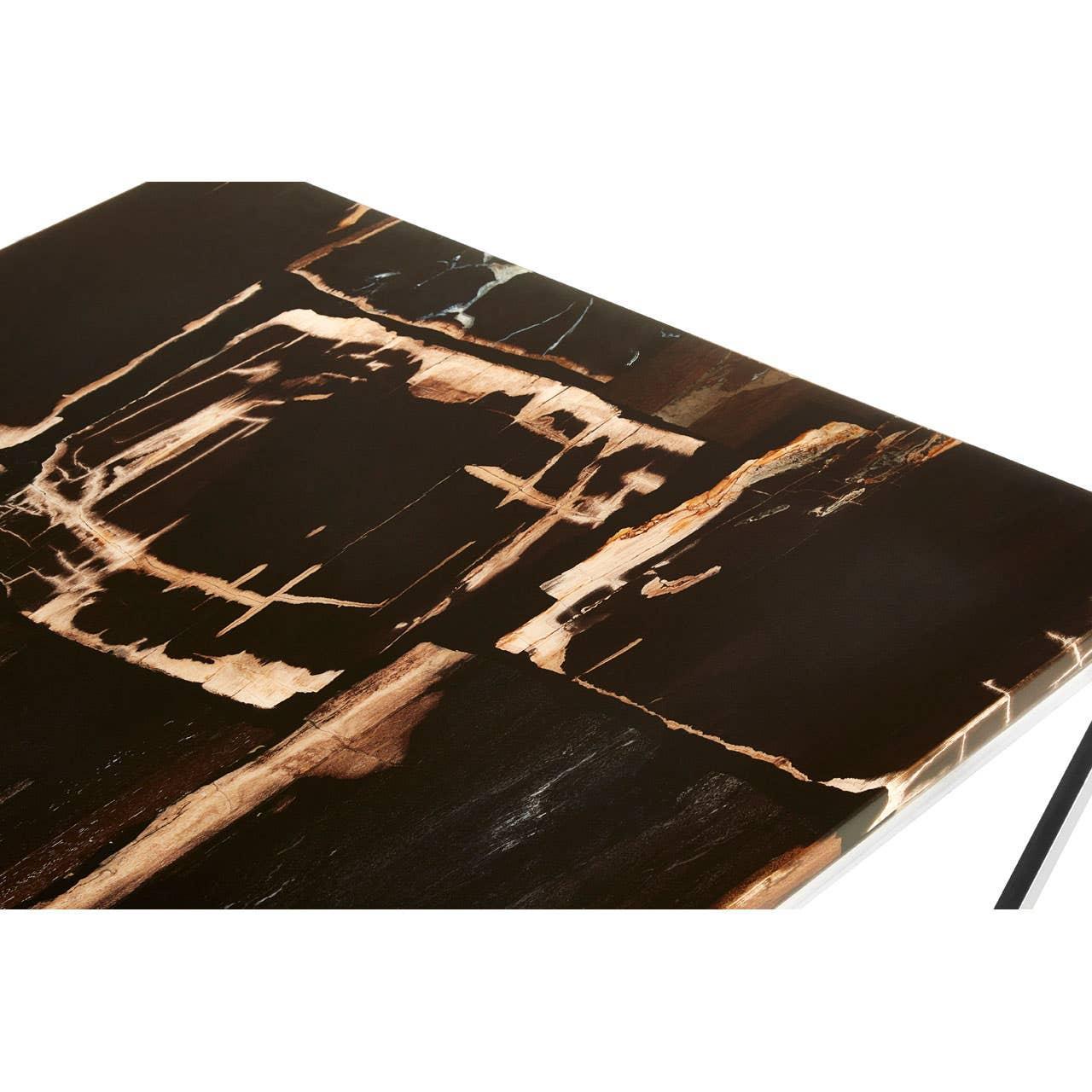 Glossy black marble dining table top with brown and white veining, close-up view