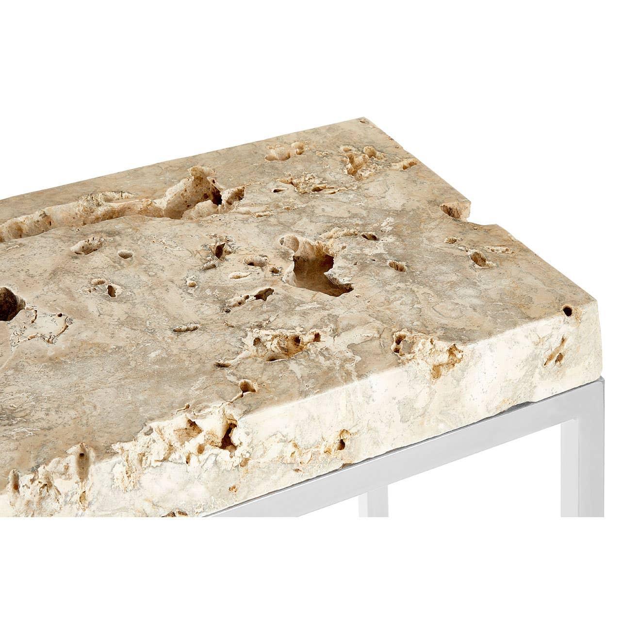 Close view of travertine coffee table with textured stone top and metal legs