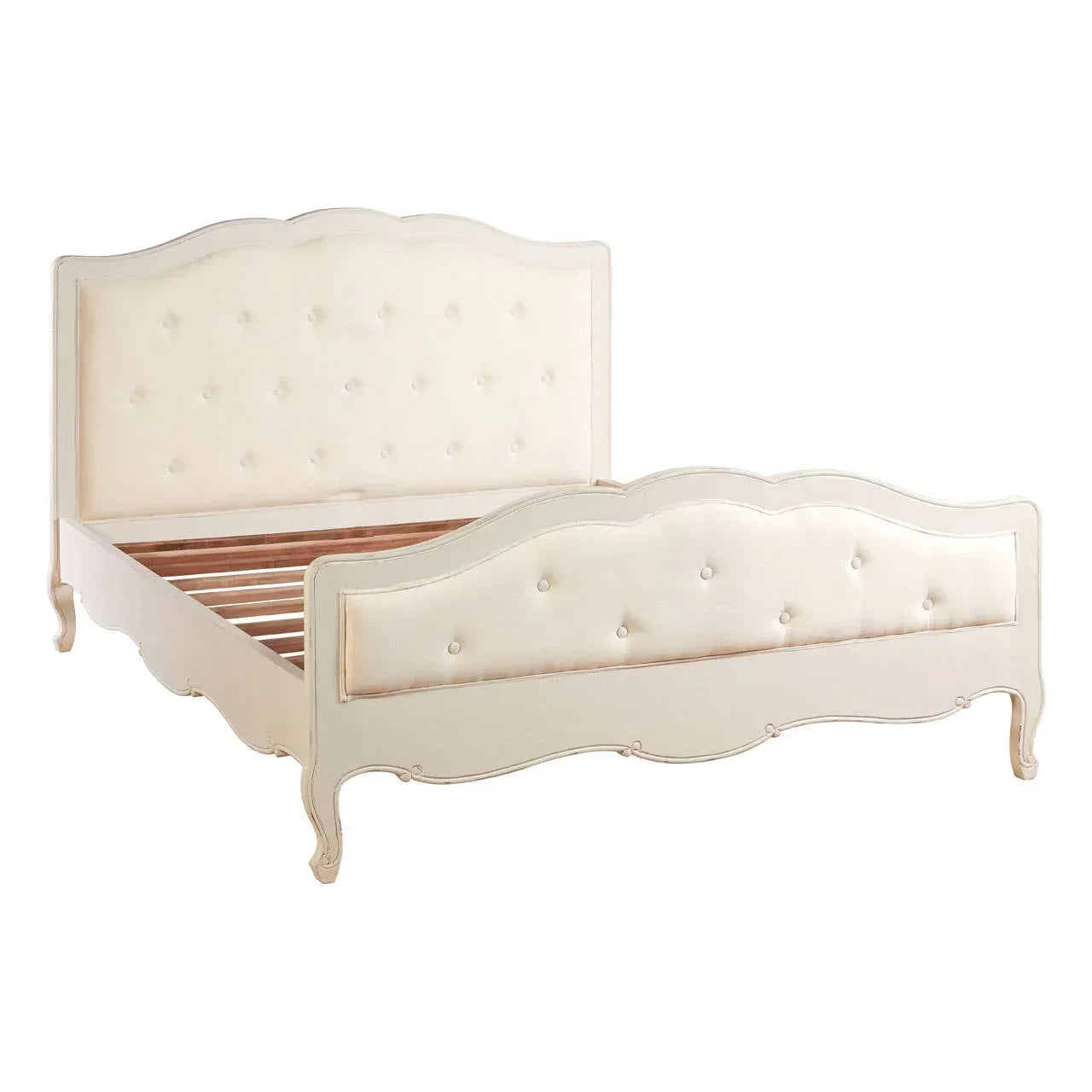 Cream upholstered bed frame with button-tufted headboard and footboard, ornate wood legs