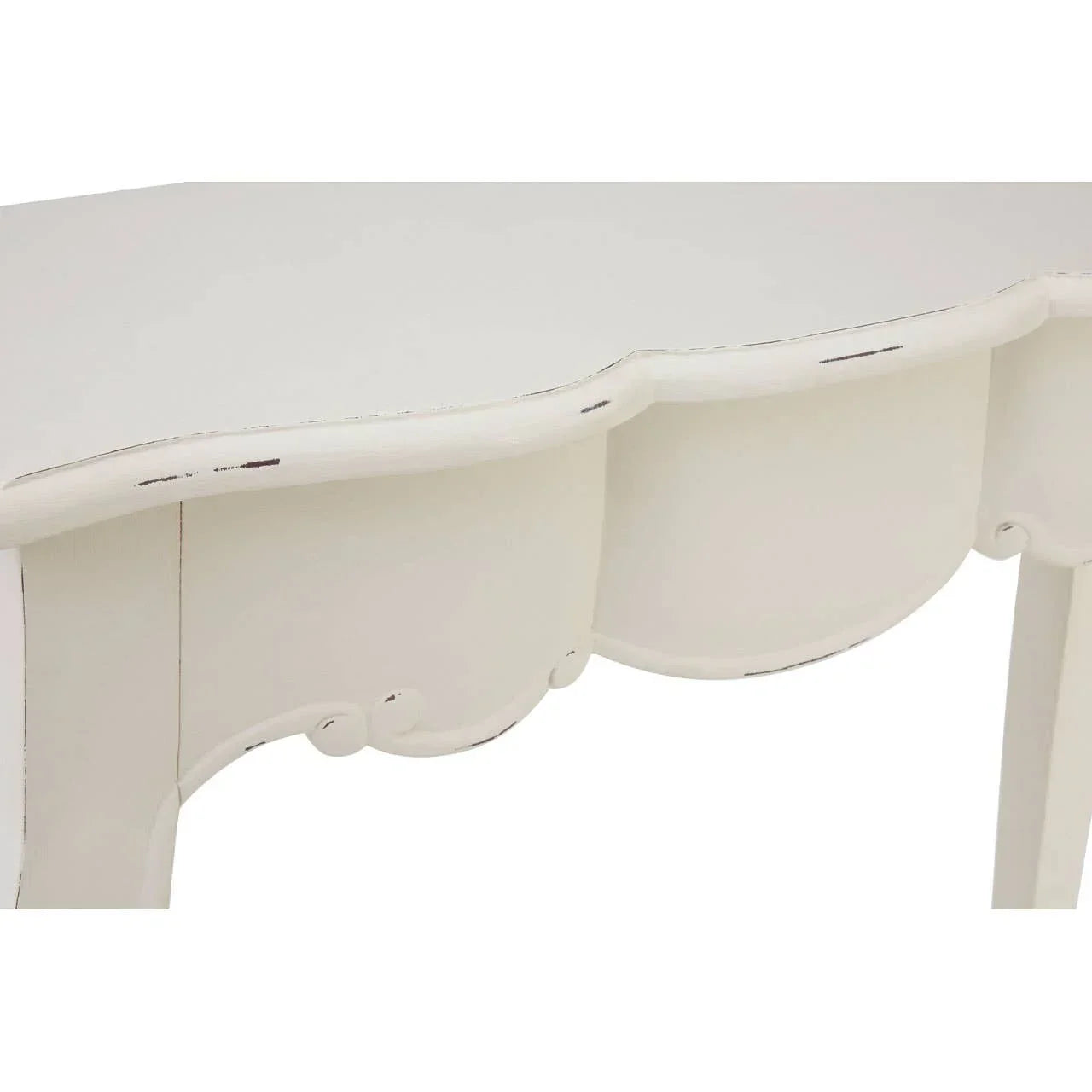 Close view of white painted wooden console table with scalloped apron and distressed edges