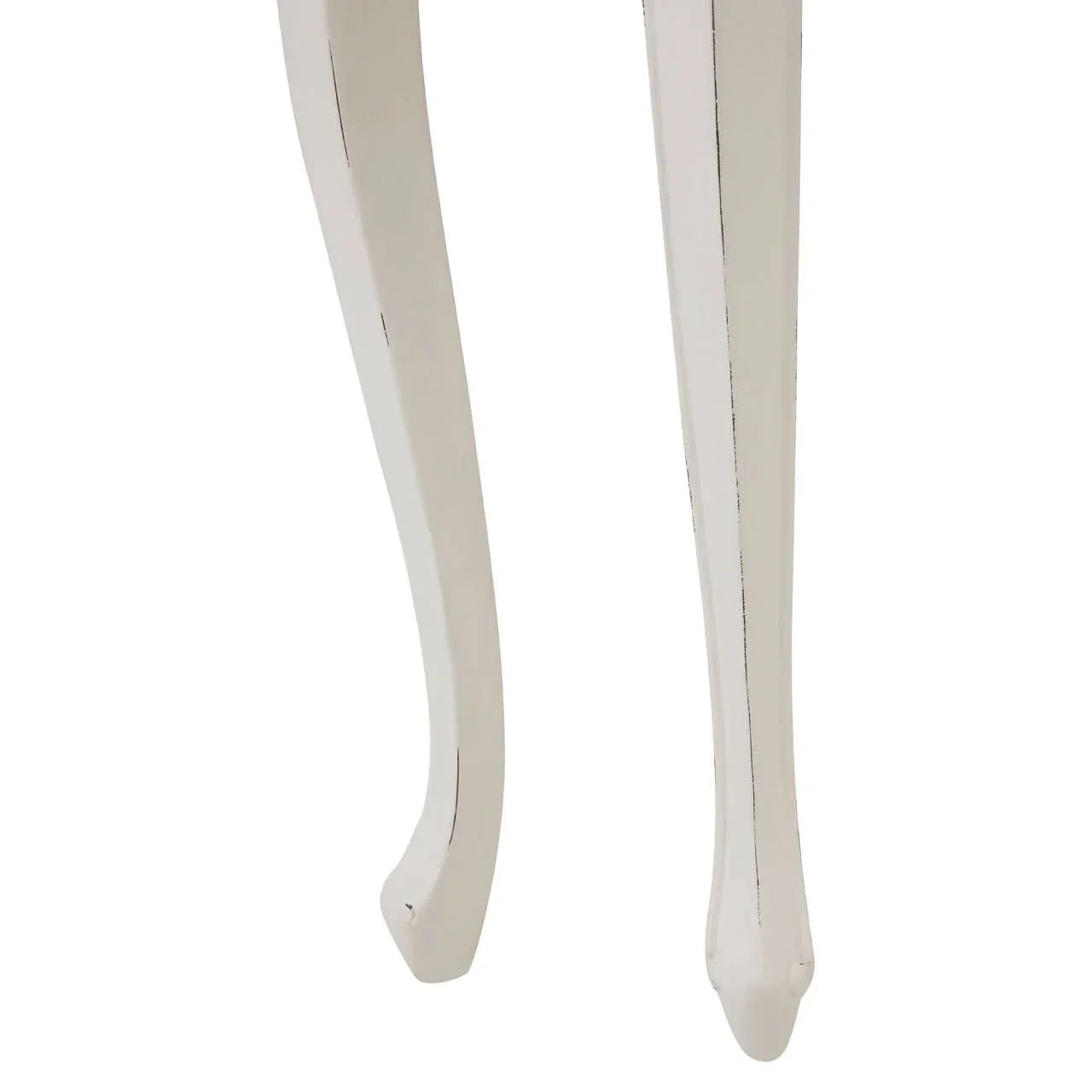 Closeup of two white wooden table legs with a curved, vintage style design