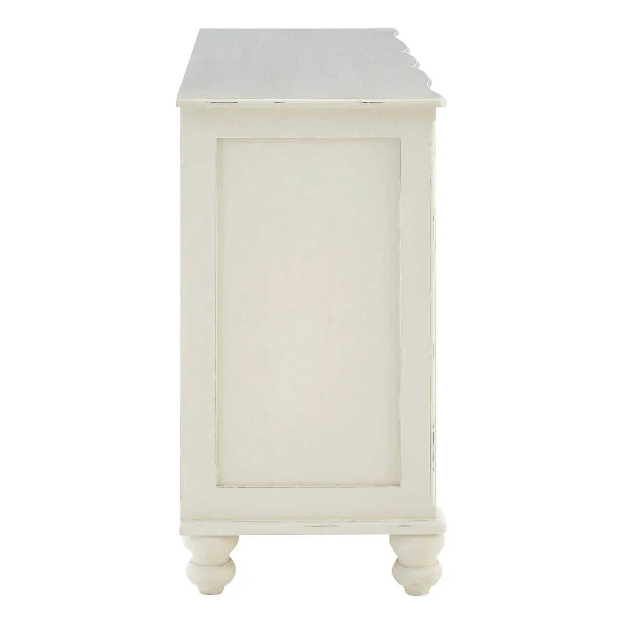 Side view of cream painted wooden chest with panel detailing and turned legs