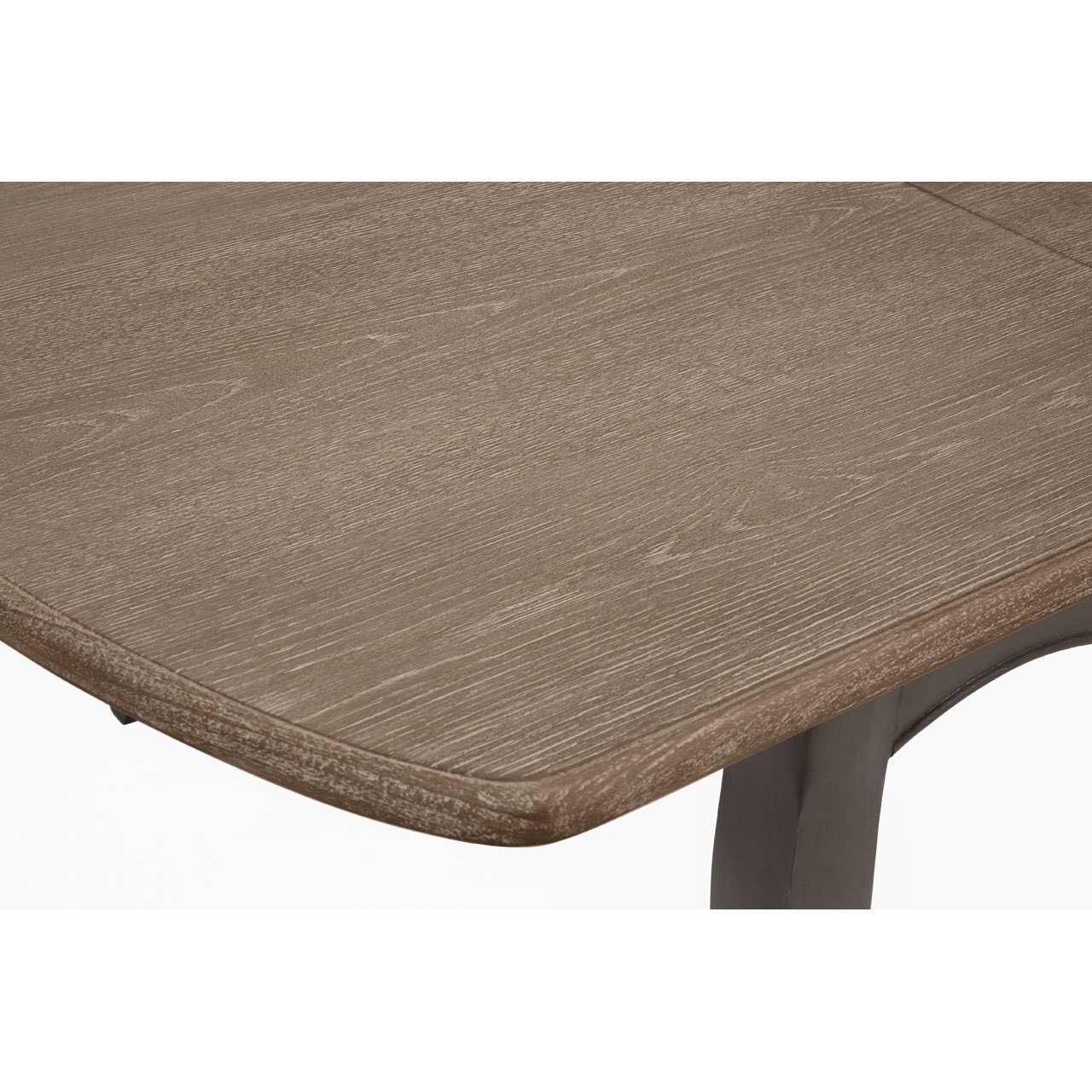 Closeup of wood grain rectangular dining table top with rounded edge and dark legs
