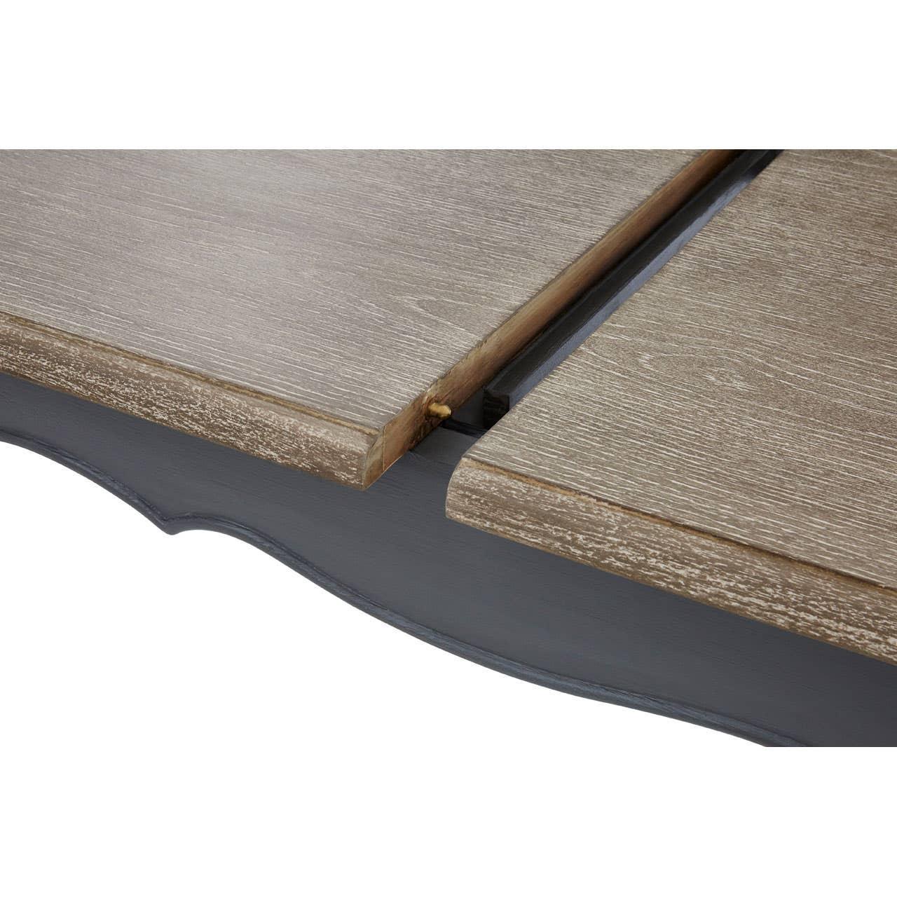 Closeup of wood extendable dining table with light oak finish and visible extension mechanism