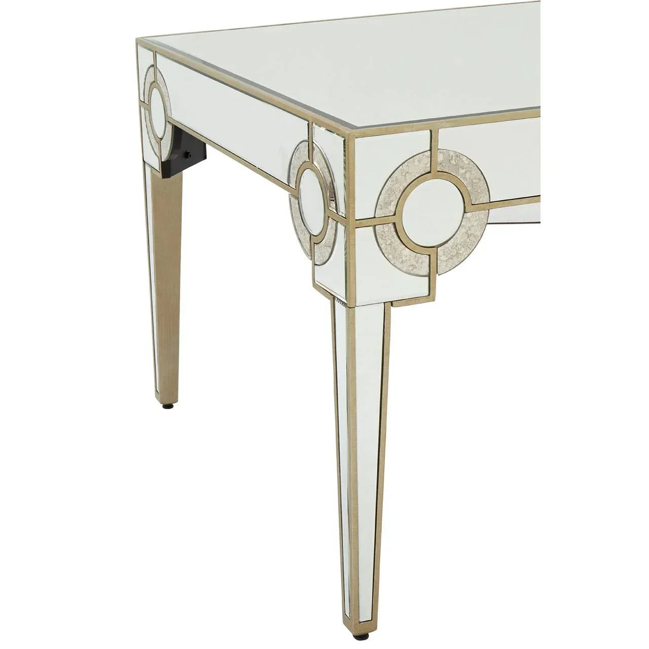 Mirrored console table corner with gold trim and geometric decorative accents