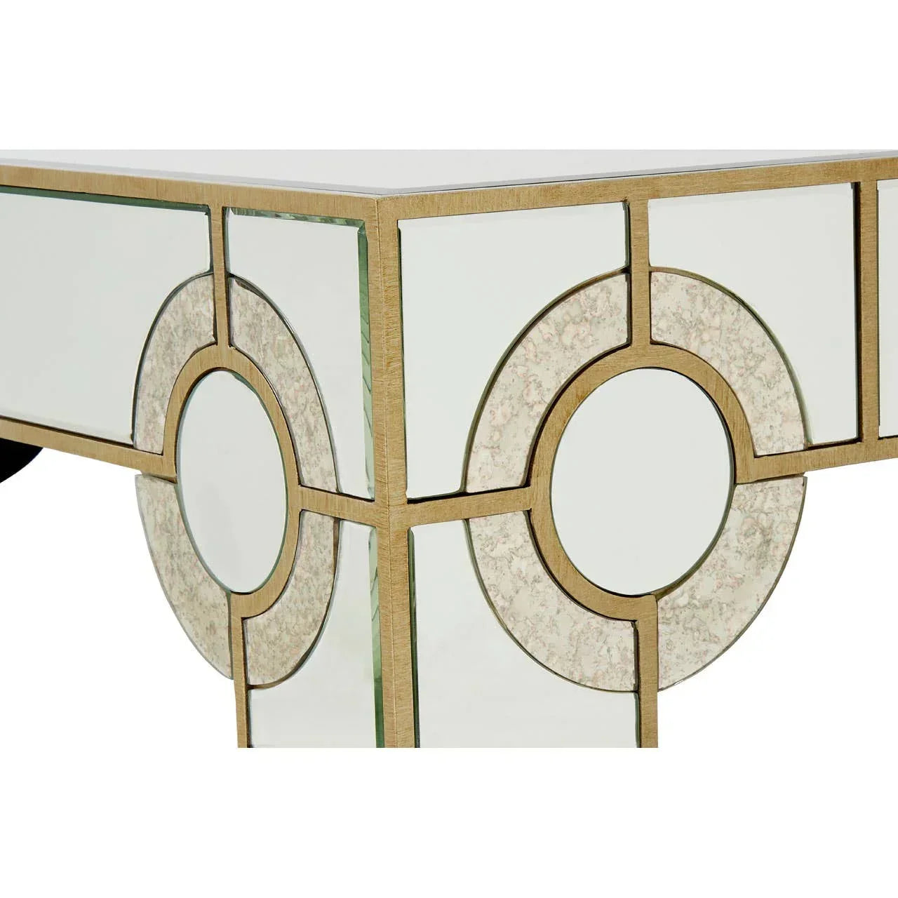 Mirrored console table corner with gold geometric trim and circular detailing