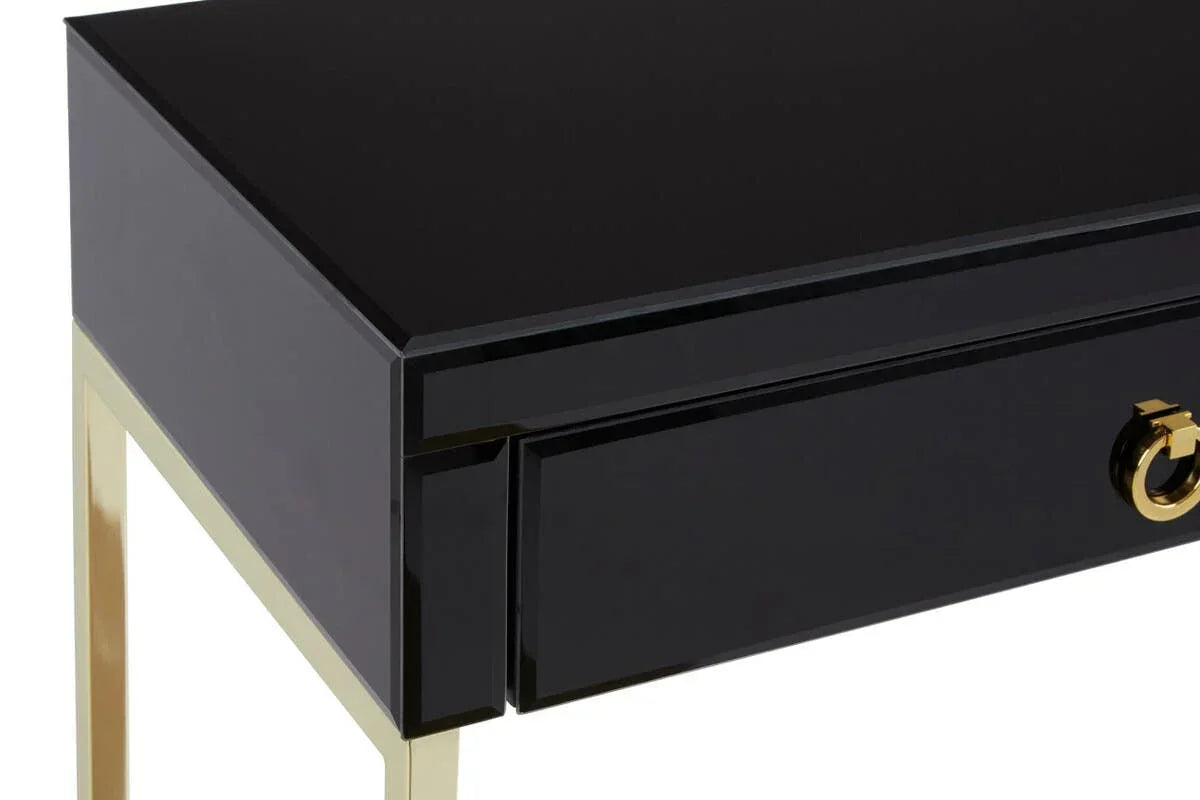 Black gloss console table with gold metal legs and gold ring handle detail