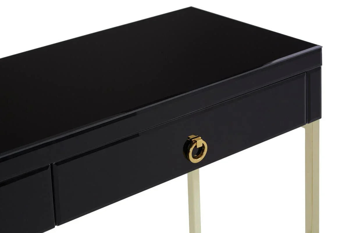 Black gloss console table with gold metal legs and gold drawer handle, angled view