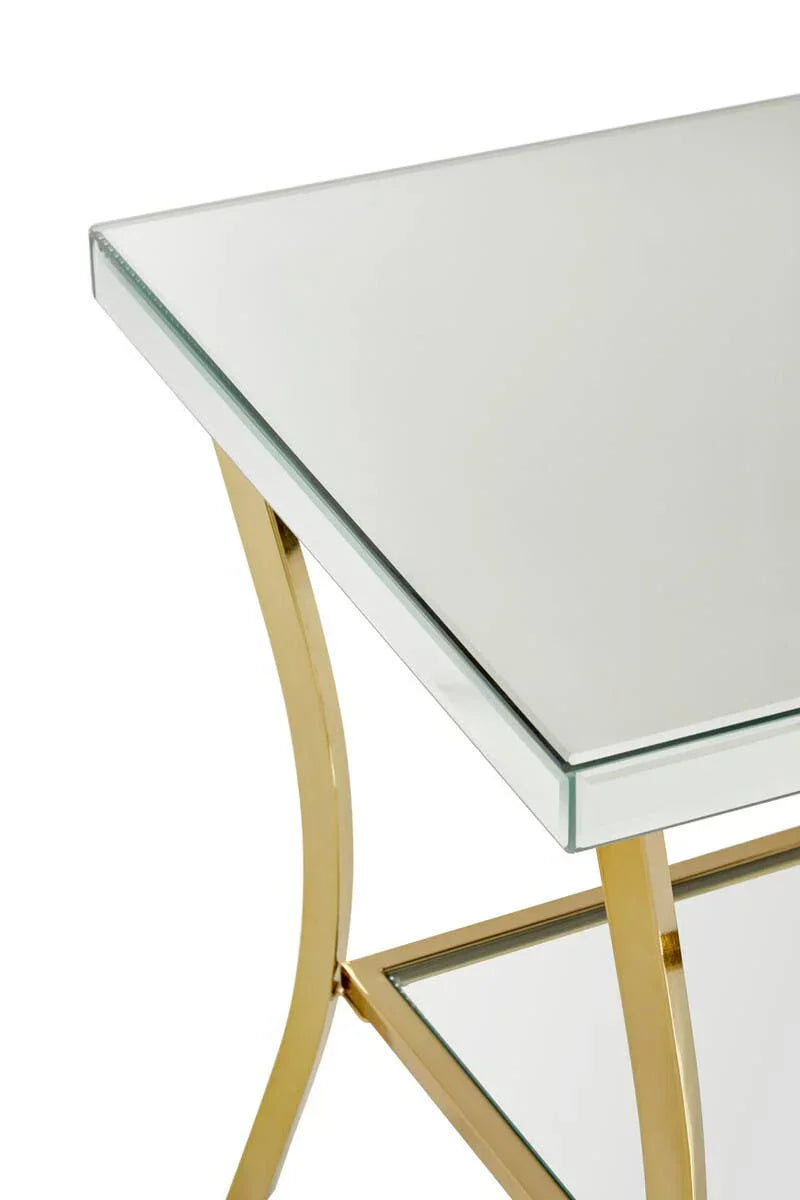 Glass side table with gold metal frame and lower shelf, close corner view