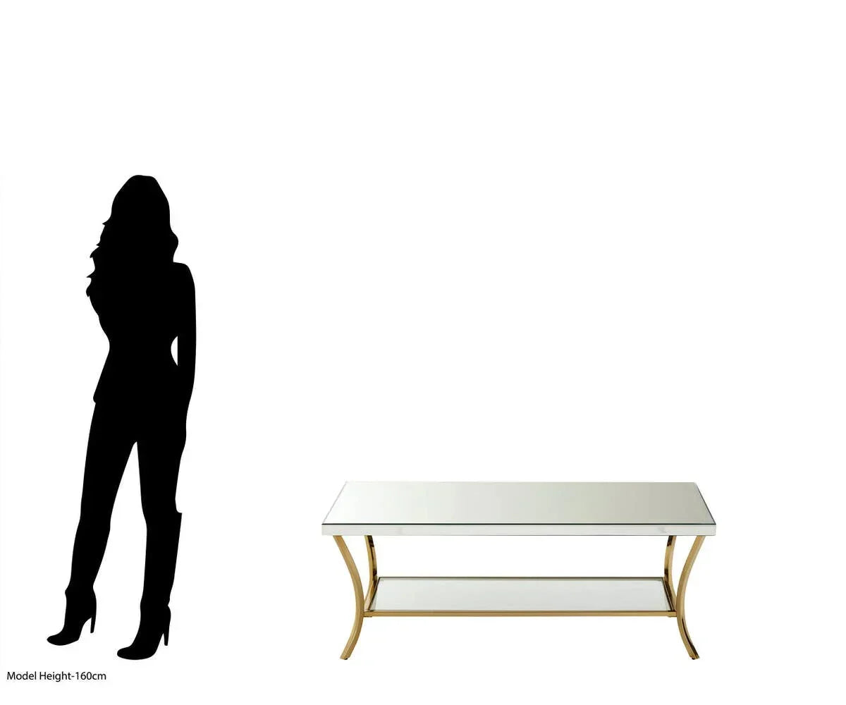 Mirrored coffee table with gold metal frame and lower shelf, shown beside silhouette for scale
