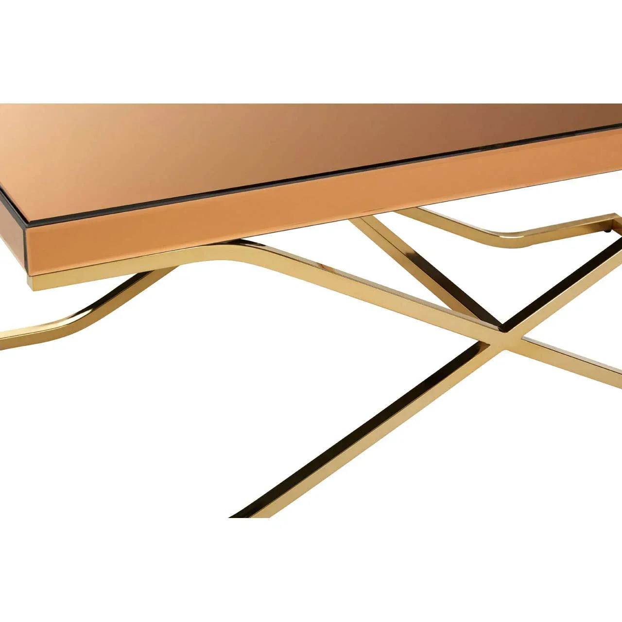 Rectangular glass coffee table with gold crossed metal legs, close-up corner view