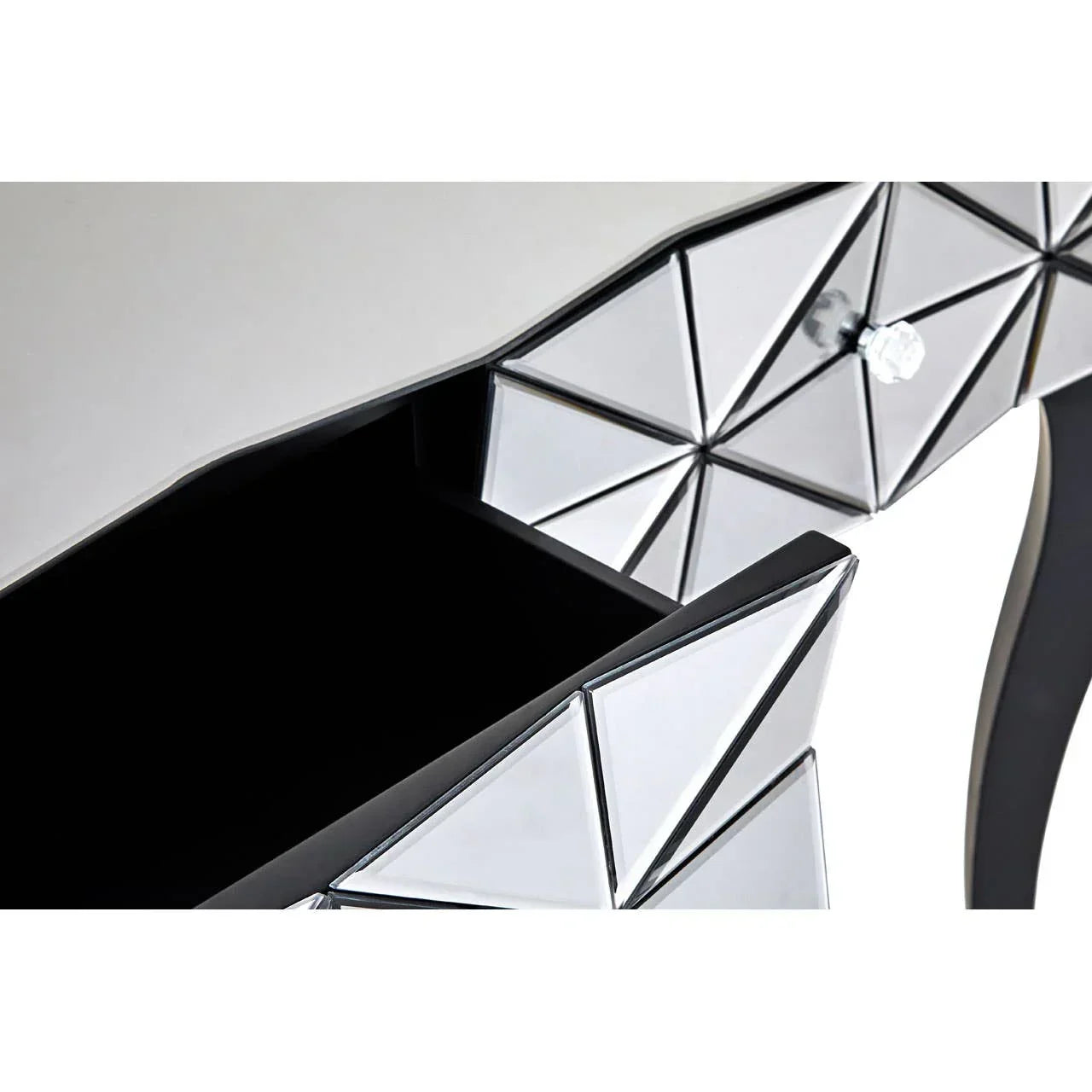 Geometric mirrored drawer front with crystal knob on modern console table