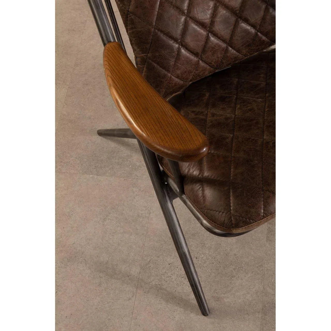 Brown leather dining chair with quilted seat and wooden armrest on metal frame