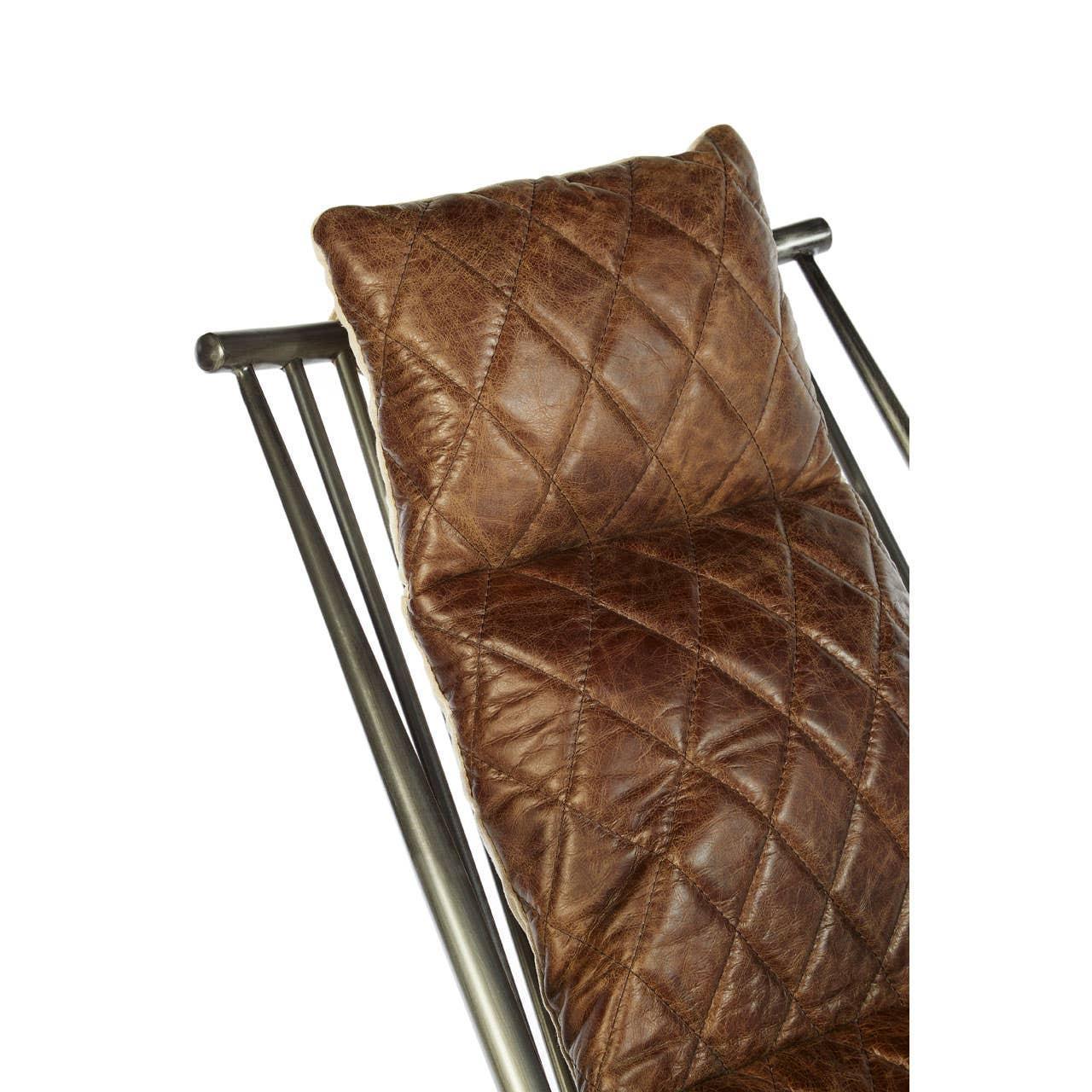 Brown quilted leather cushion on metal chair backrest, close-up view