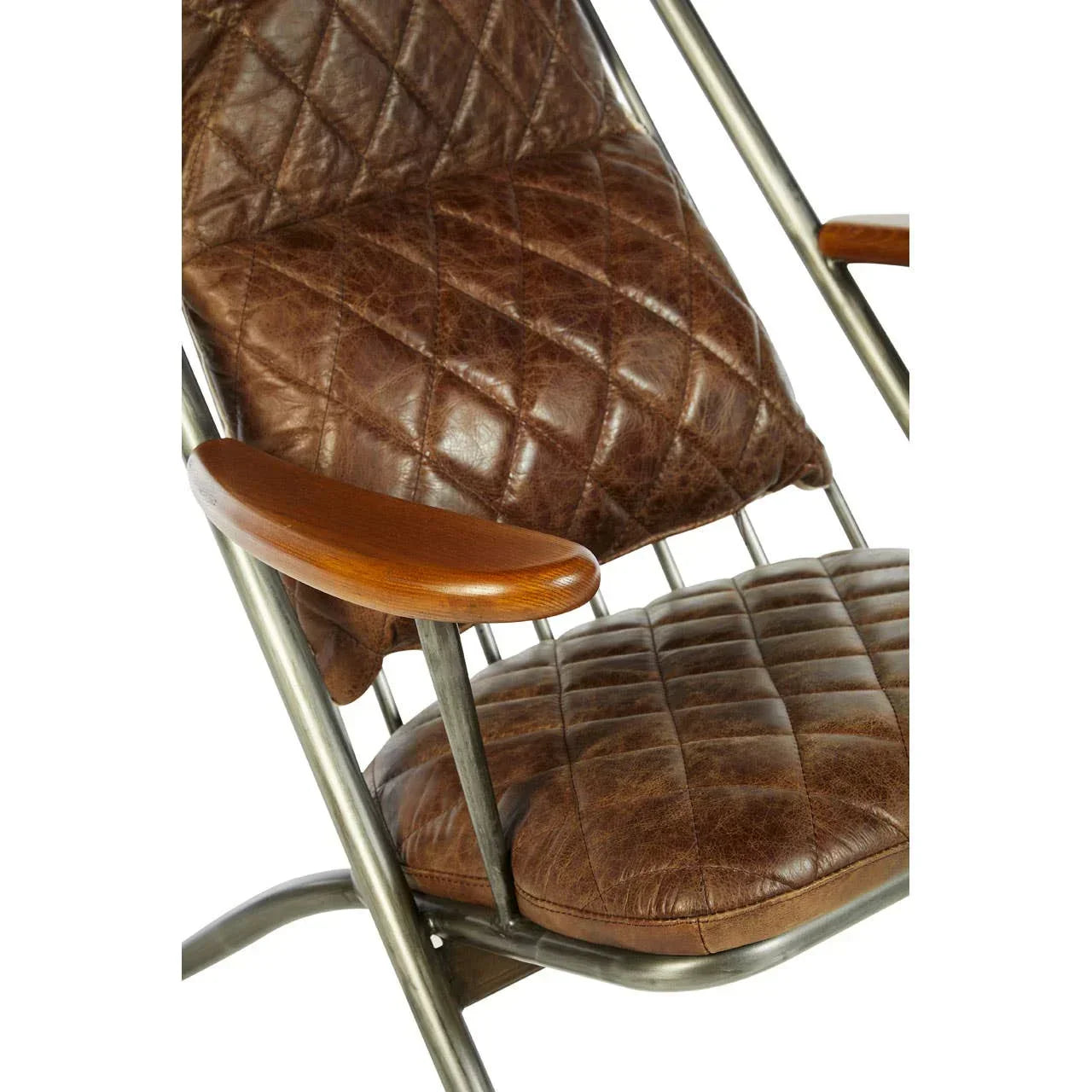 Closeup of brown leather armchair with diamond quilting and metal frame