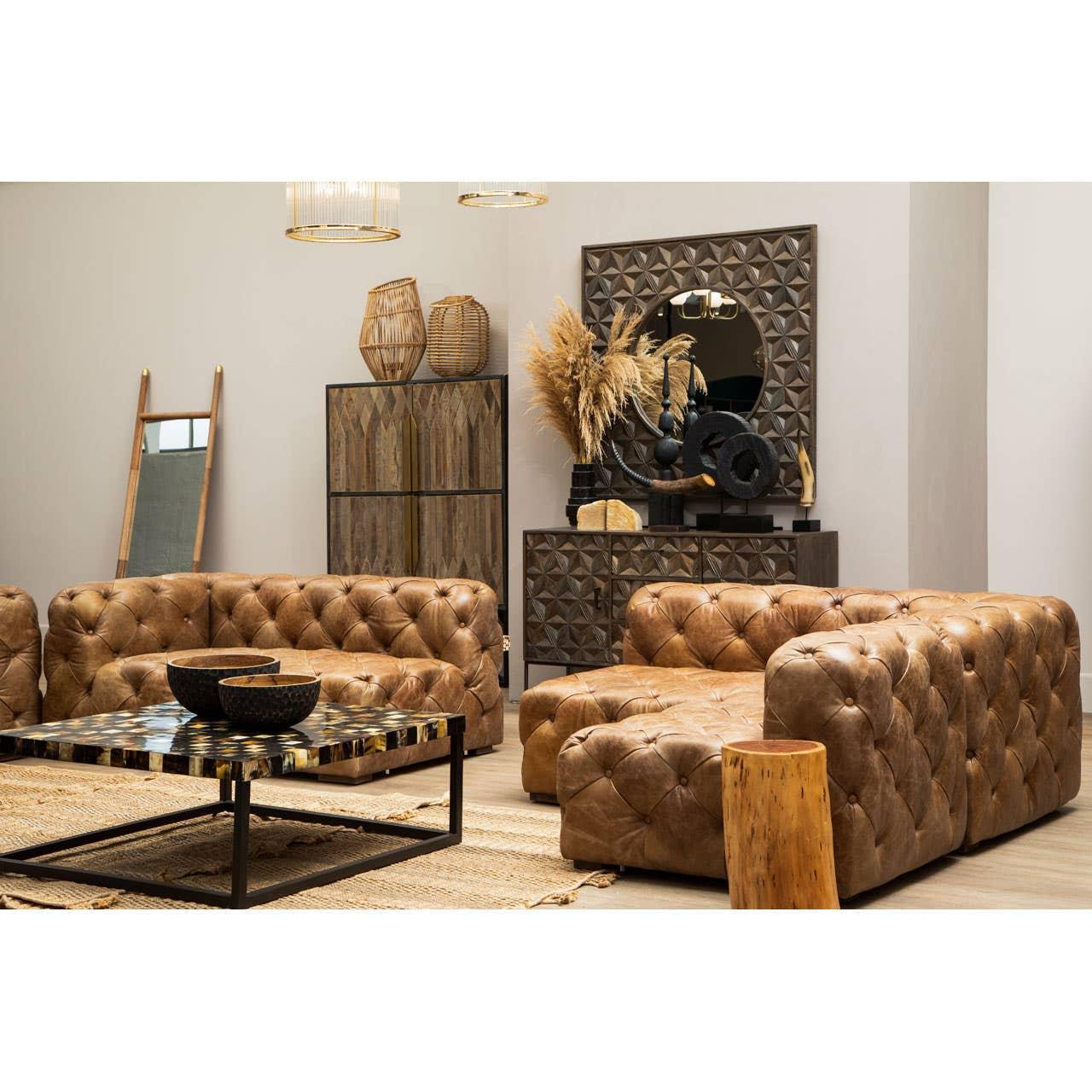 Brown leather chesterfield sofas and patterned coffee table in modern living room setting