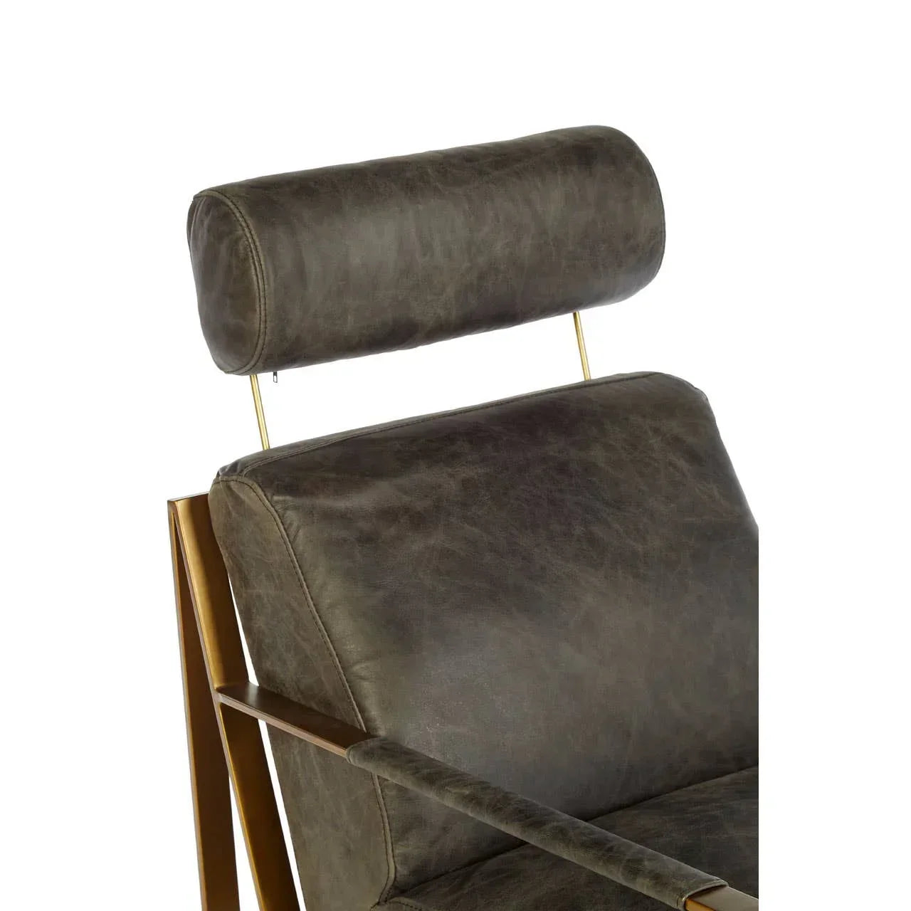 Close-up of leather armchair with headrest and gold metal frame