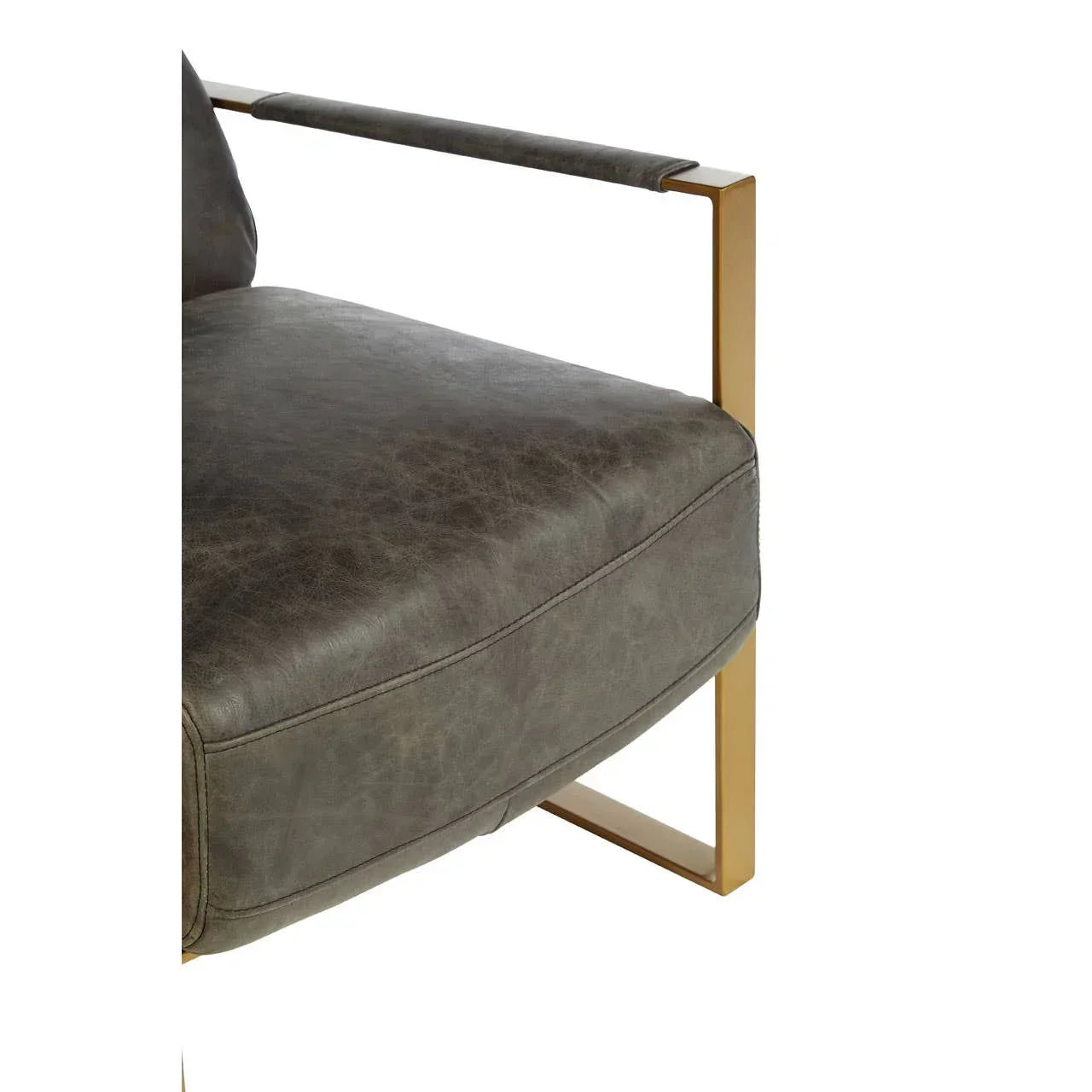Grey leather armchair seat with gold metal frame and padded cushion, close-up view