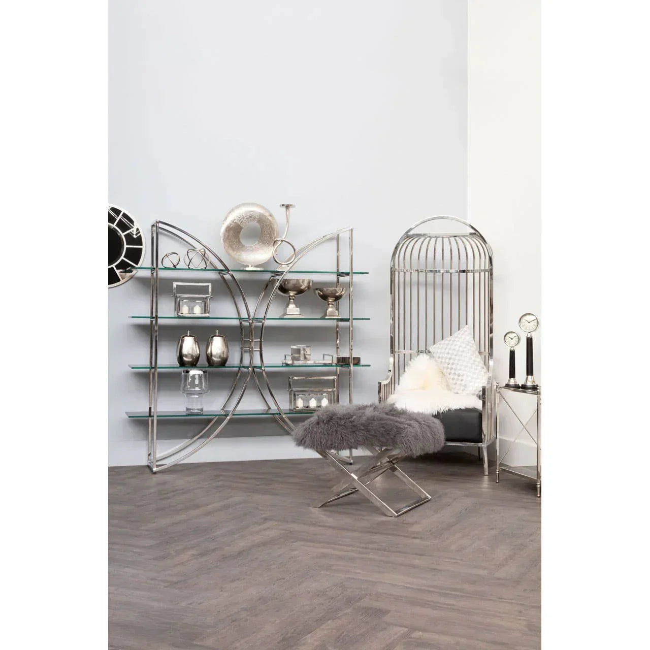 Modern silver metal and glass shelving unit with decorative ornaments in living room setting