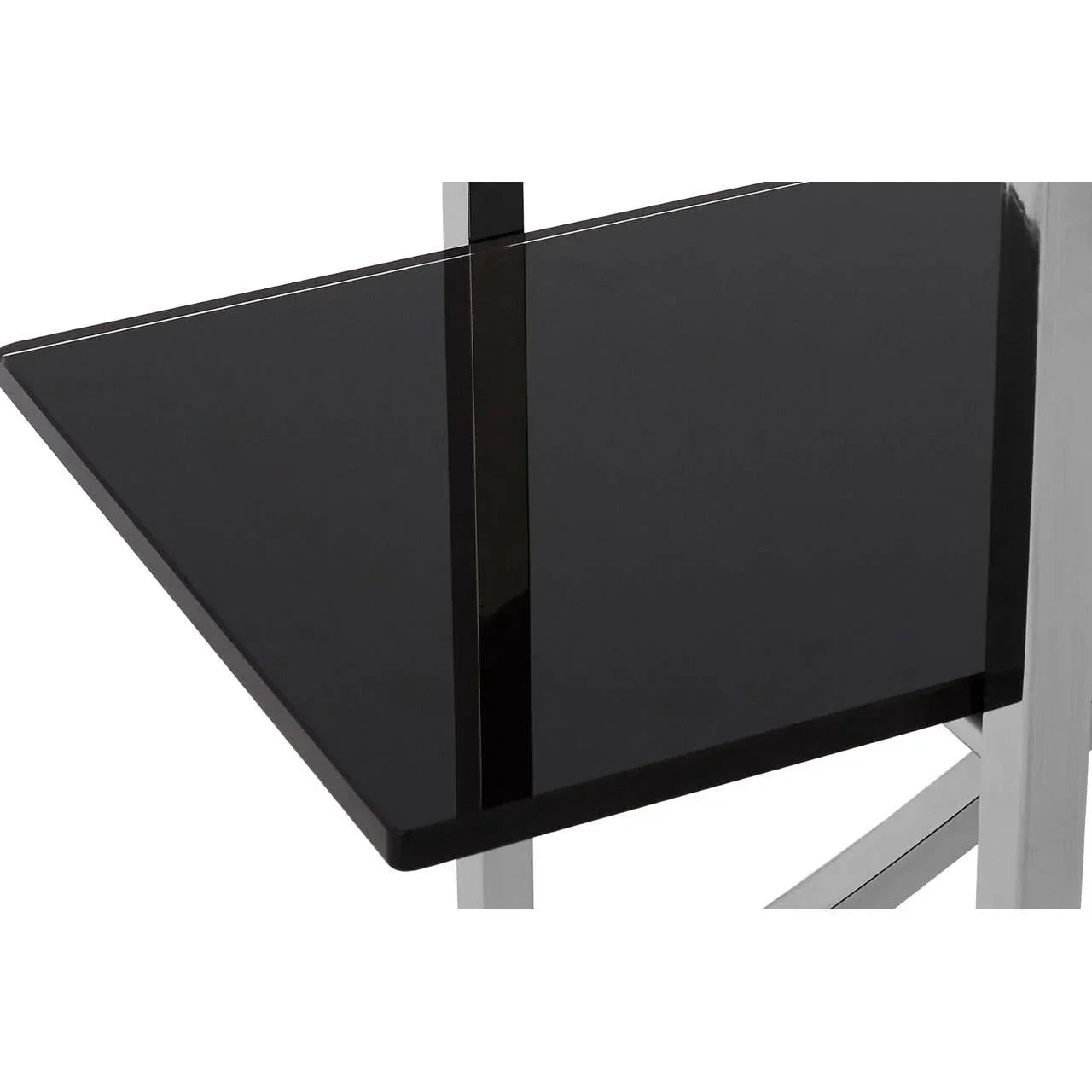 Black glass table top with chrome metal legs, close-up furniture detail