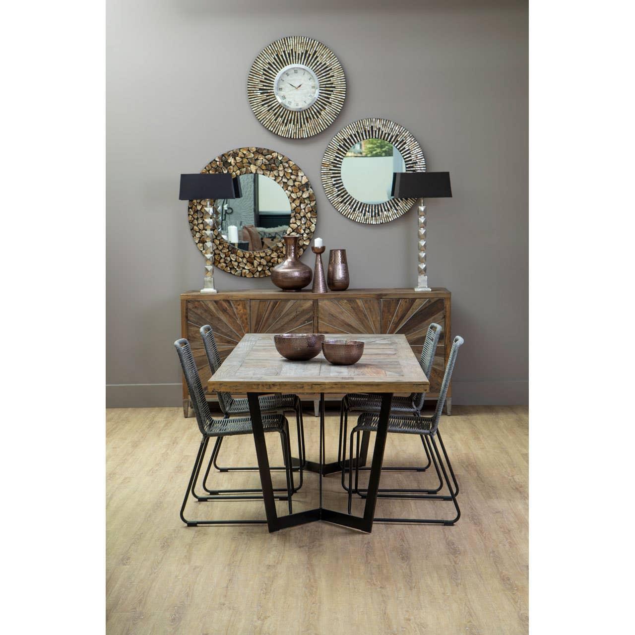 Wood dining table set with four chairs, sideboard, decorative mirrors, and vases in modern room