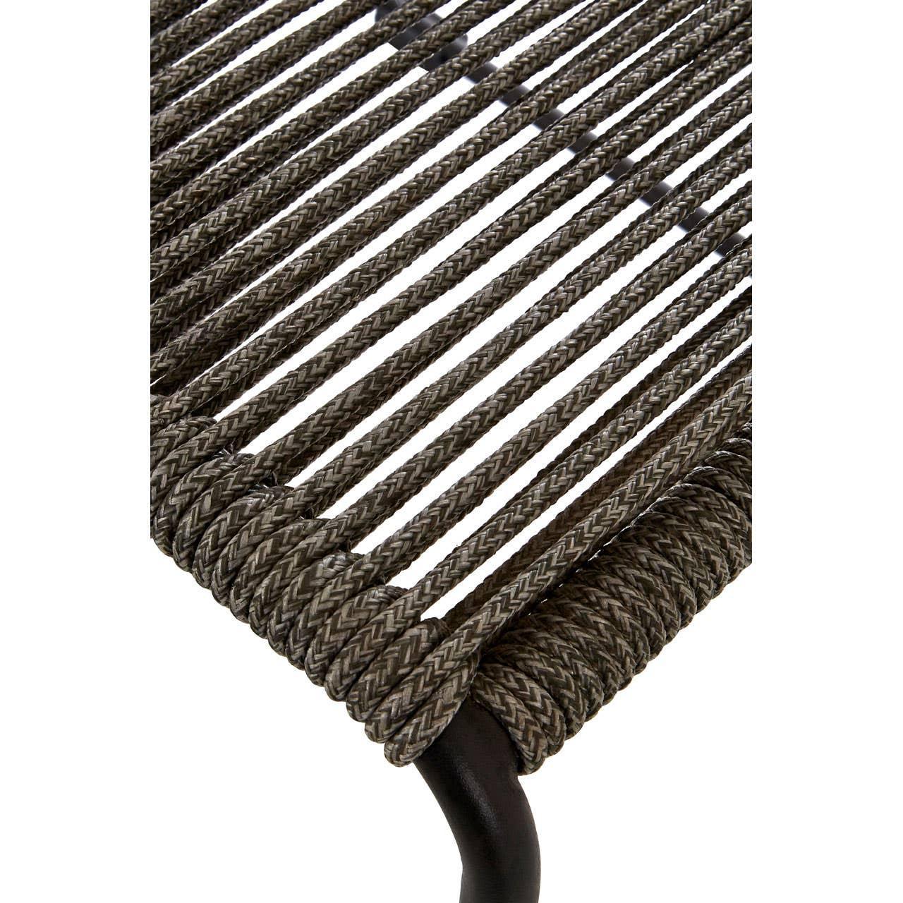 Closeup of woven rattan dining chair seat with black metal frame detail