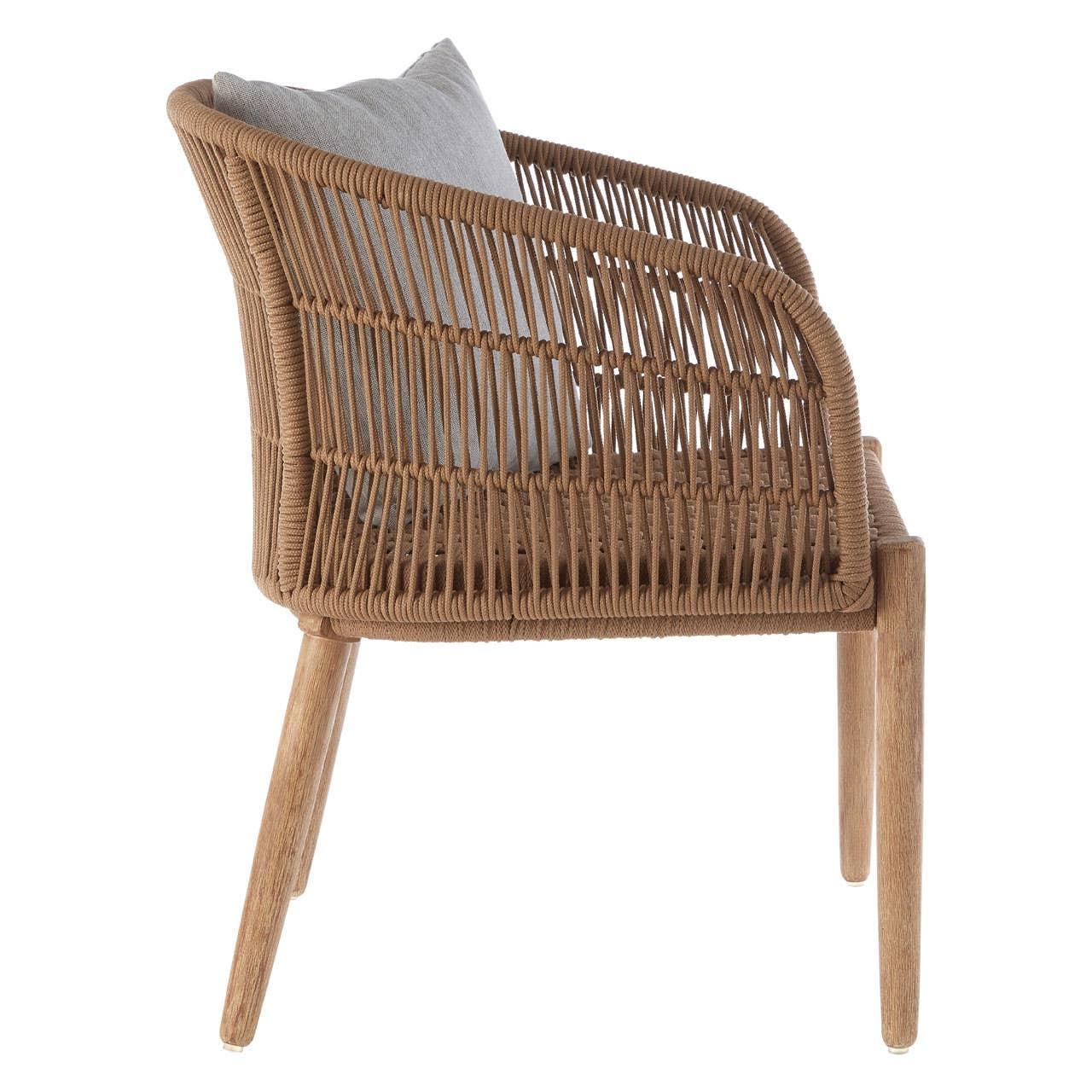 Side view of rattan dining chair with light brown wooden legs and grey cushion
