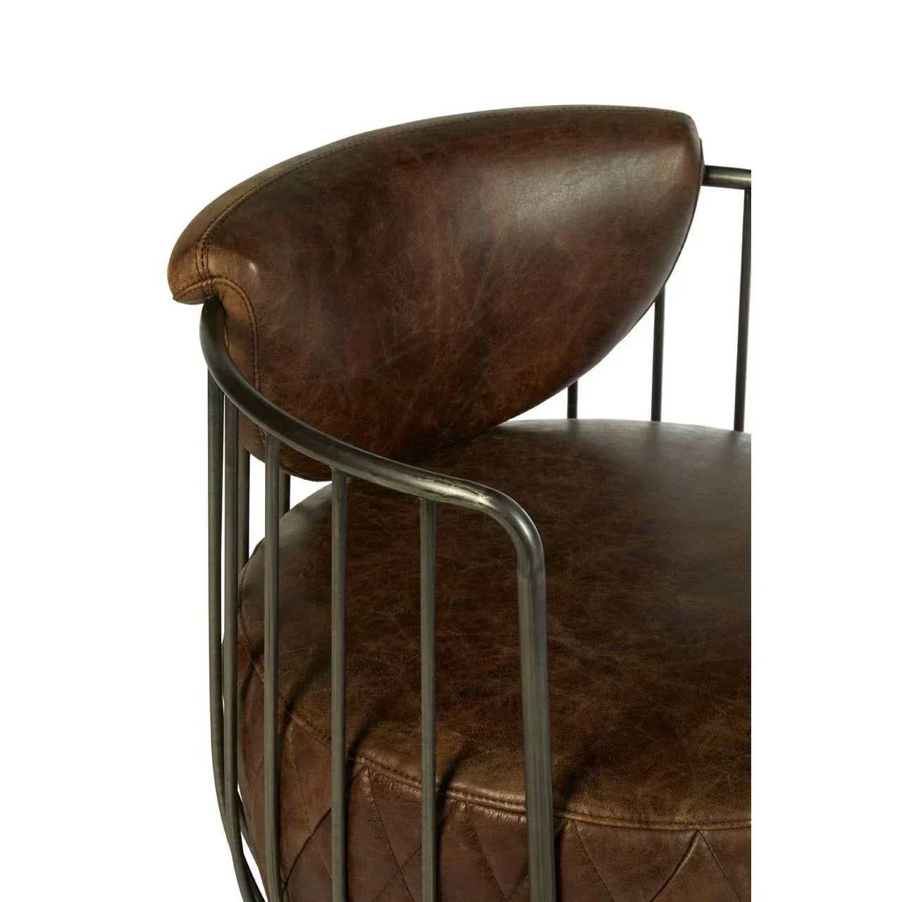 Close-up of brown leather dining chair with metal frame and quilted seat detail