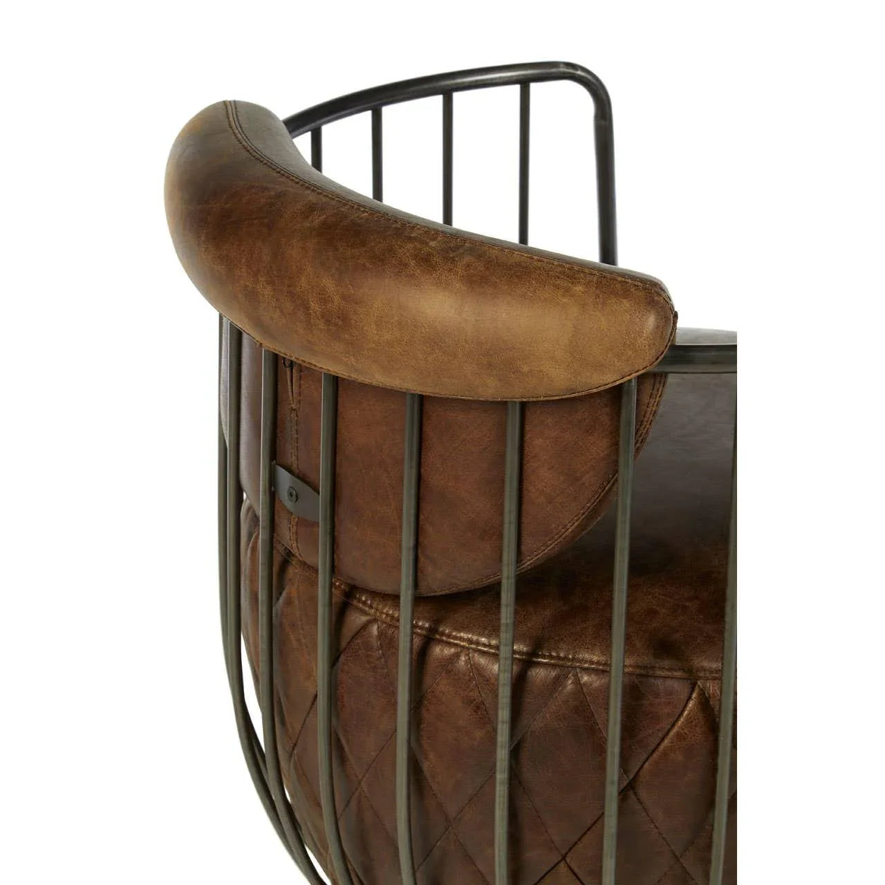 Brown leather armchair with quilted seat and curved metal frame, close-up of backrest
