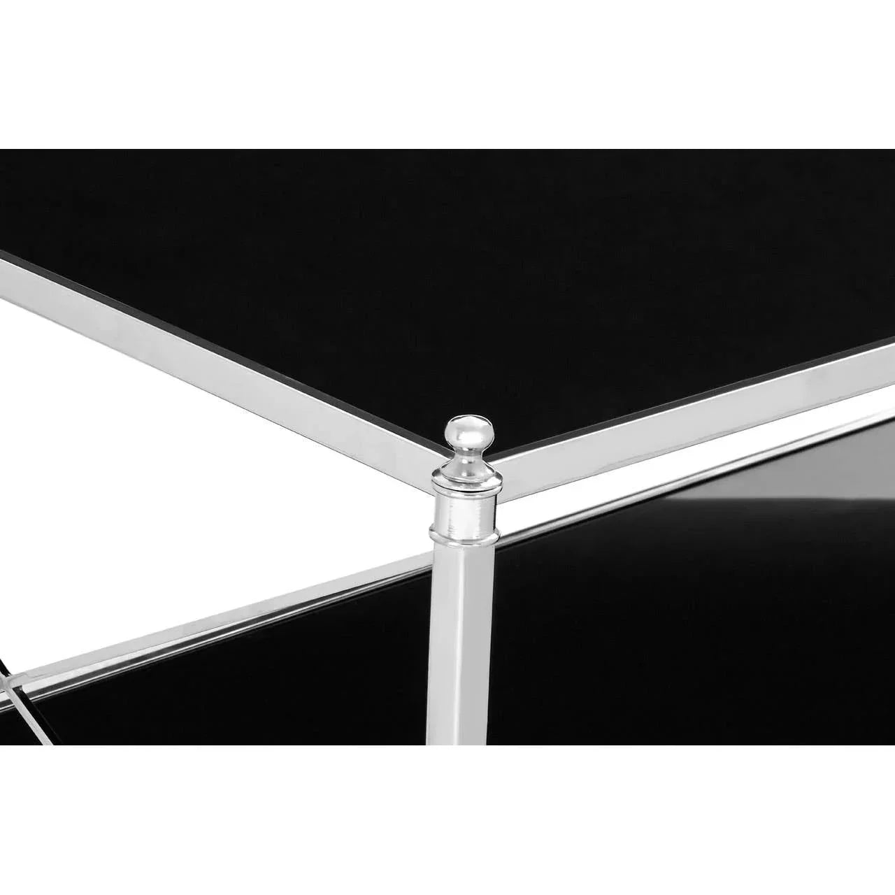 Black glass coffee table with chrome frame and decorative corner finial detail