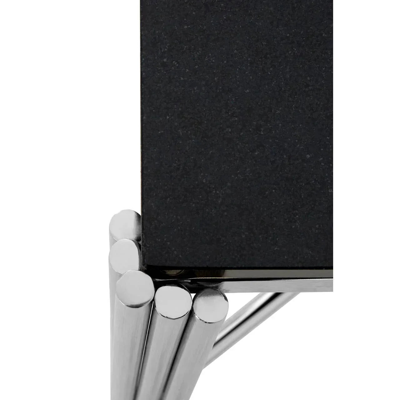 Close up of black stone tabletop with chrome metal legs, modern dining table detail