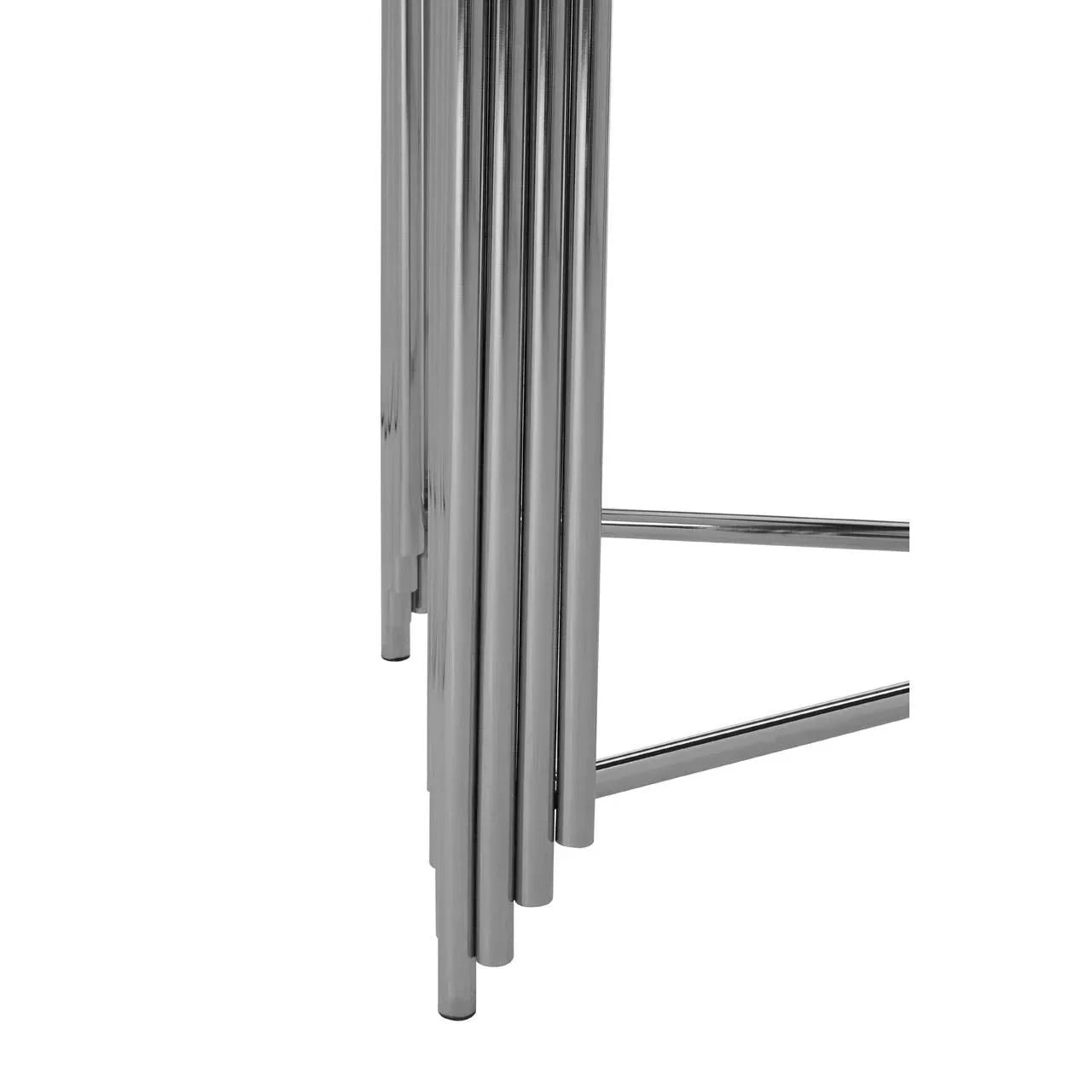 Chrome dining table legs with tubular metal frame, close-up on modern design details