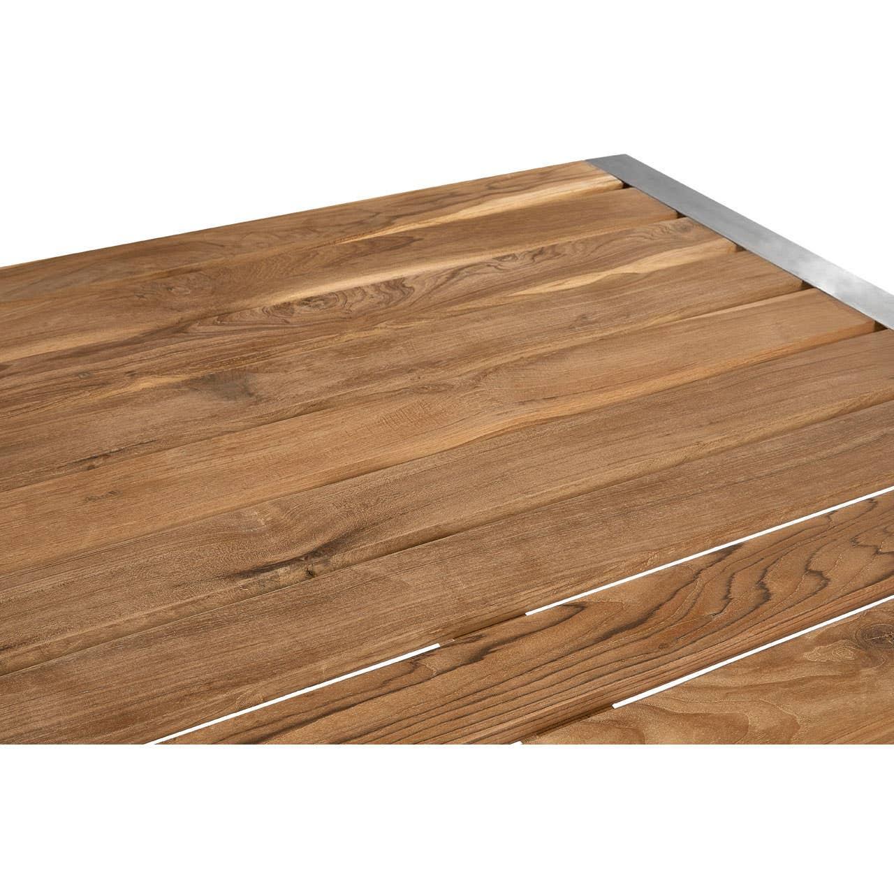 Close-up of wooden dining table top with visible wood grain and metal edge trim