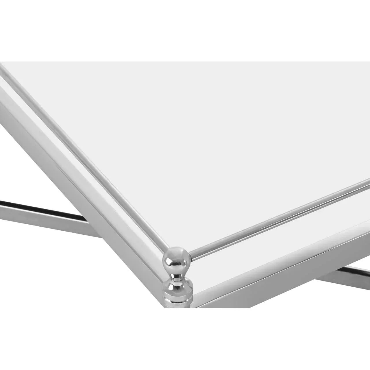 Corner detail of chrome and glass coffee table with ball finial and metal frame