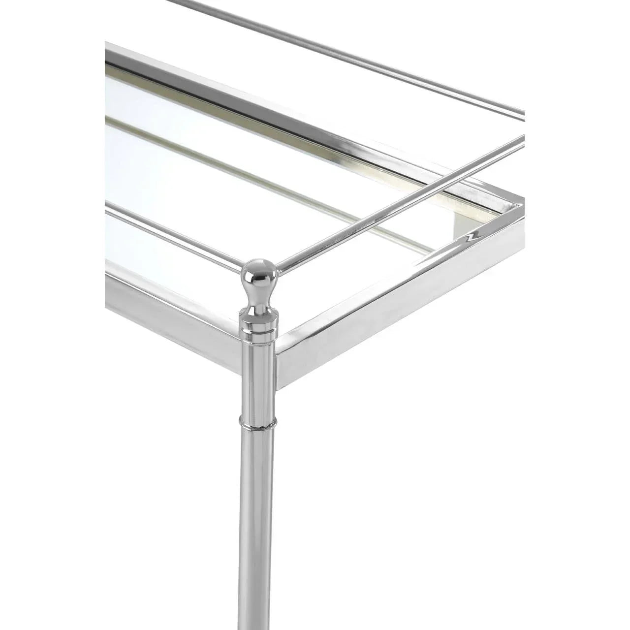 Close-up of chrome metal and glass console table corner with rail detailing