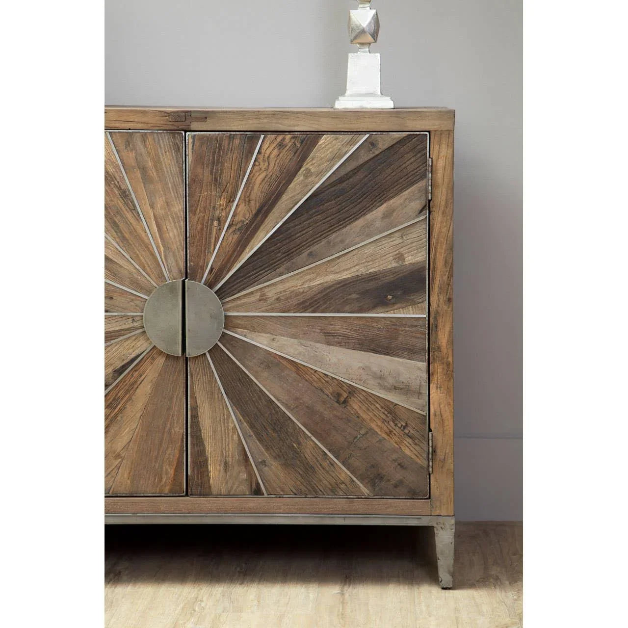 Wooden sideboard with sunburst pattern doors and metal handles on wooden floor