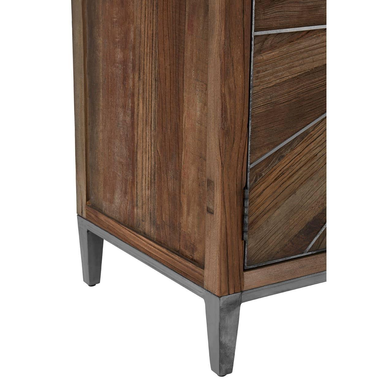 Corner view of wooden cabinet with metal legs and geometric patterned door panel